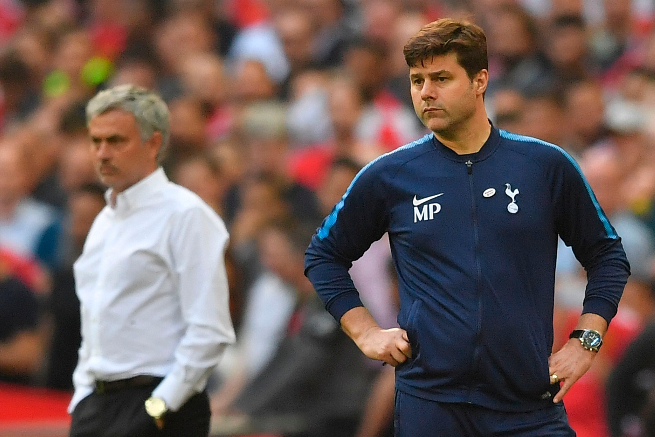 Manchester United's Portuguese manager Jose Mourinho (L) and Tottenham Hotspur's Argentinian head coach Mauricio Pochettino look on during the English FA Cup semi-final football match between Tottenham Hotspur and Manchester United at Wembley Stadium in L