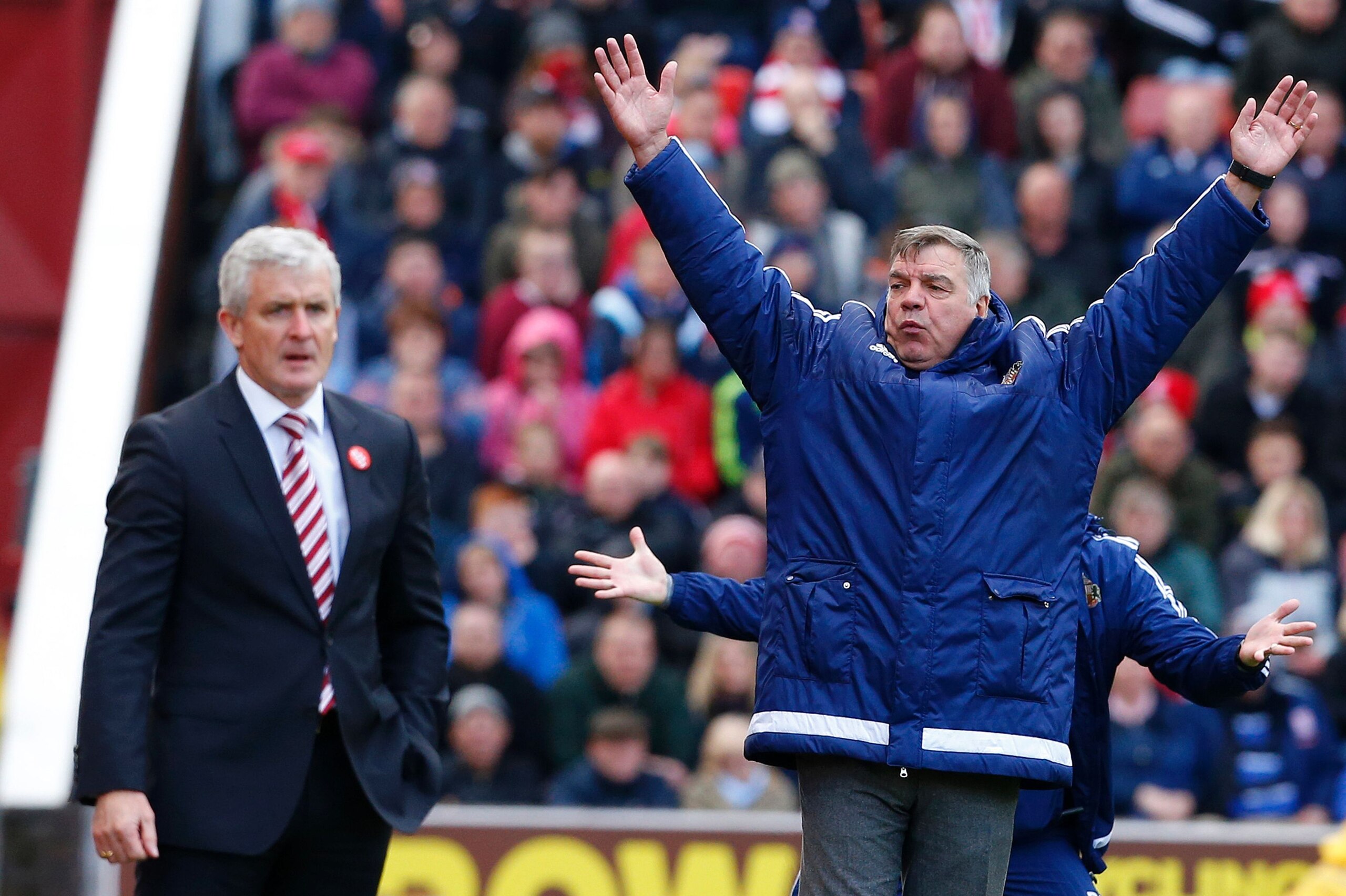 Sunderland's English manager Sam Allardyce (R) reacts next to Stoke City's Welsh manager Mark Hughes (L) as Sunderland are awarded a late penalty during the English Premier League football match between Stoke City and Sunderland at the Britannia Stadium i