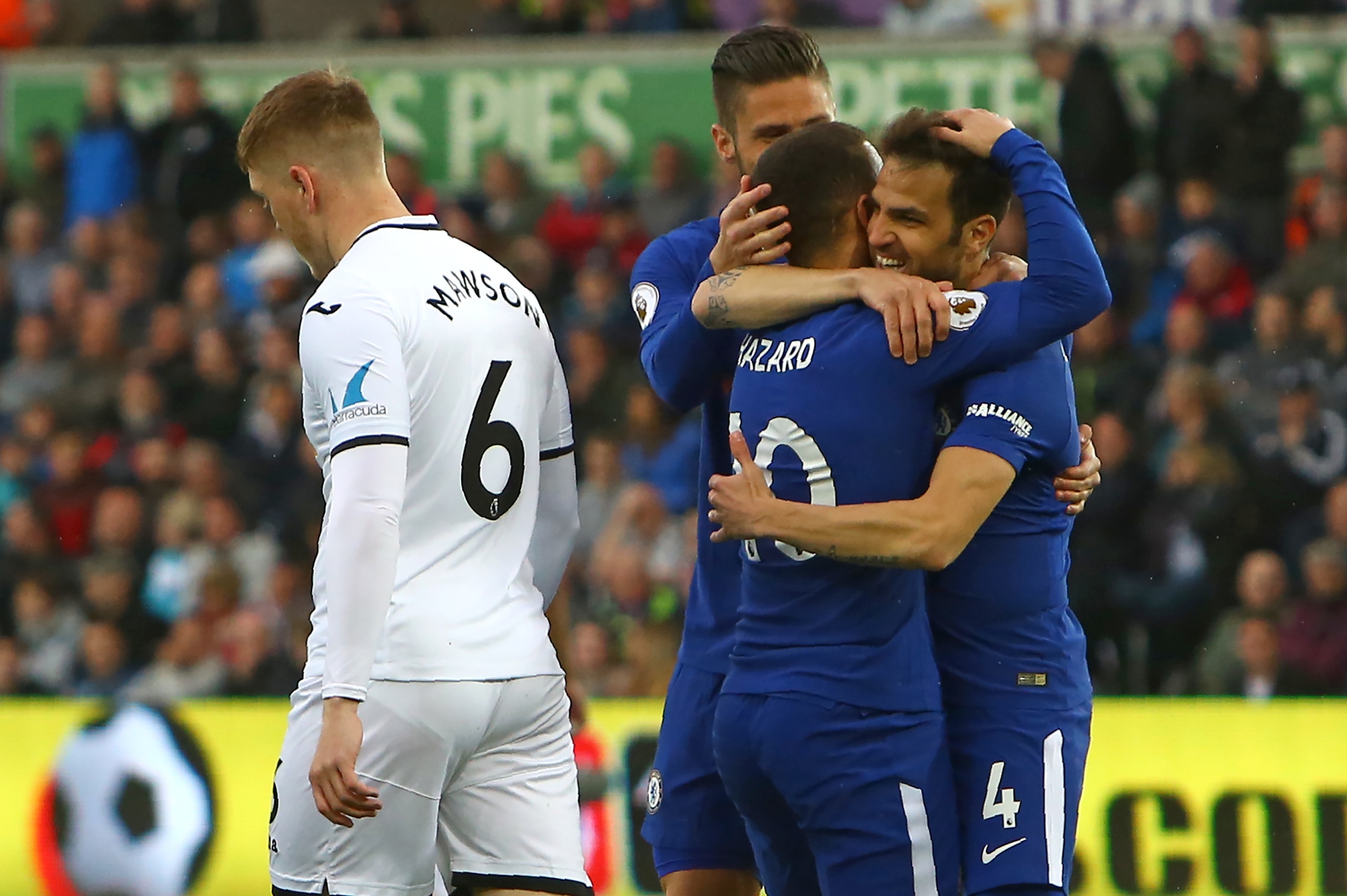 Chelsea's Spanish midfielder Cesc Fabregas (R) celebrates with teammates after scoring the opening goal of the English Premier League football match between Swansea City and Chelsea at The Liberty Stadium in Swansea, south Wales on April 28, 2018. (Photo 