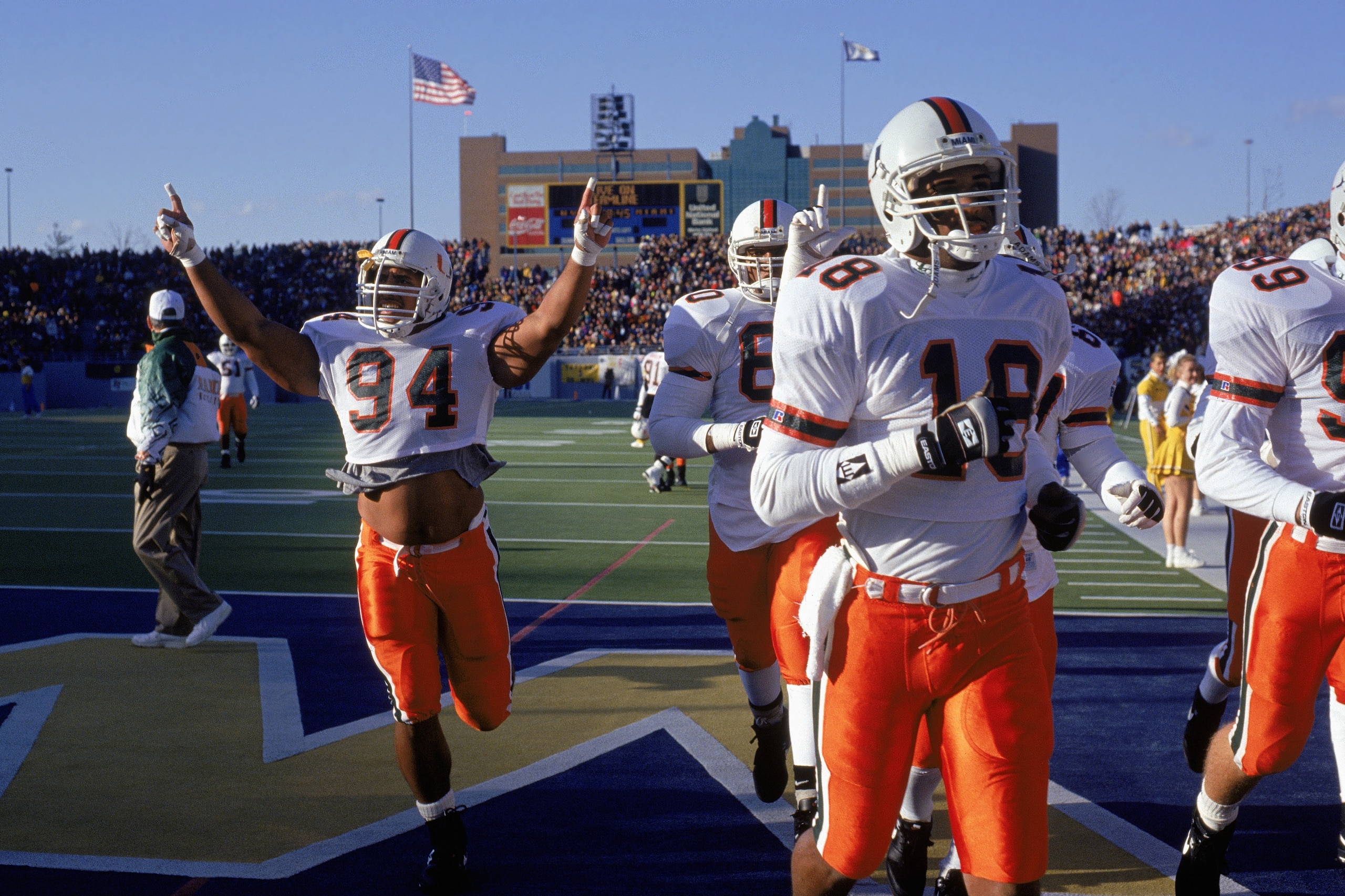 NOVEMBER 20:  Defensive end Dwayne Johnson #94 of the University of Miami Hurricanes raises his arms as he and his teammates leave the field during the NCAA game against West Virginia University on November 20, 1993.  Dwayne Johnson is also known as 'The 