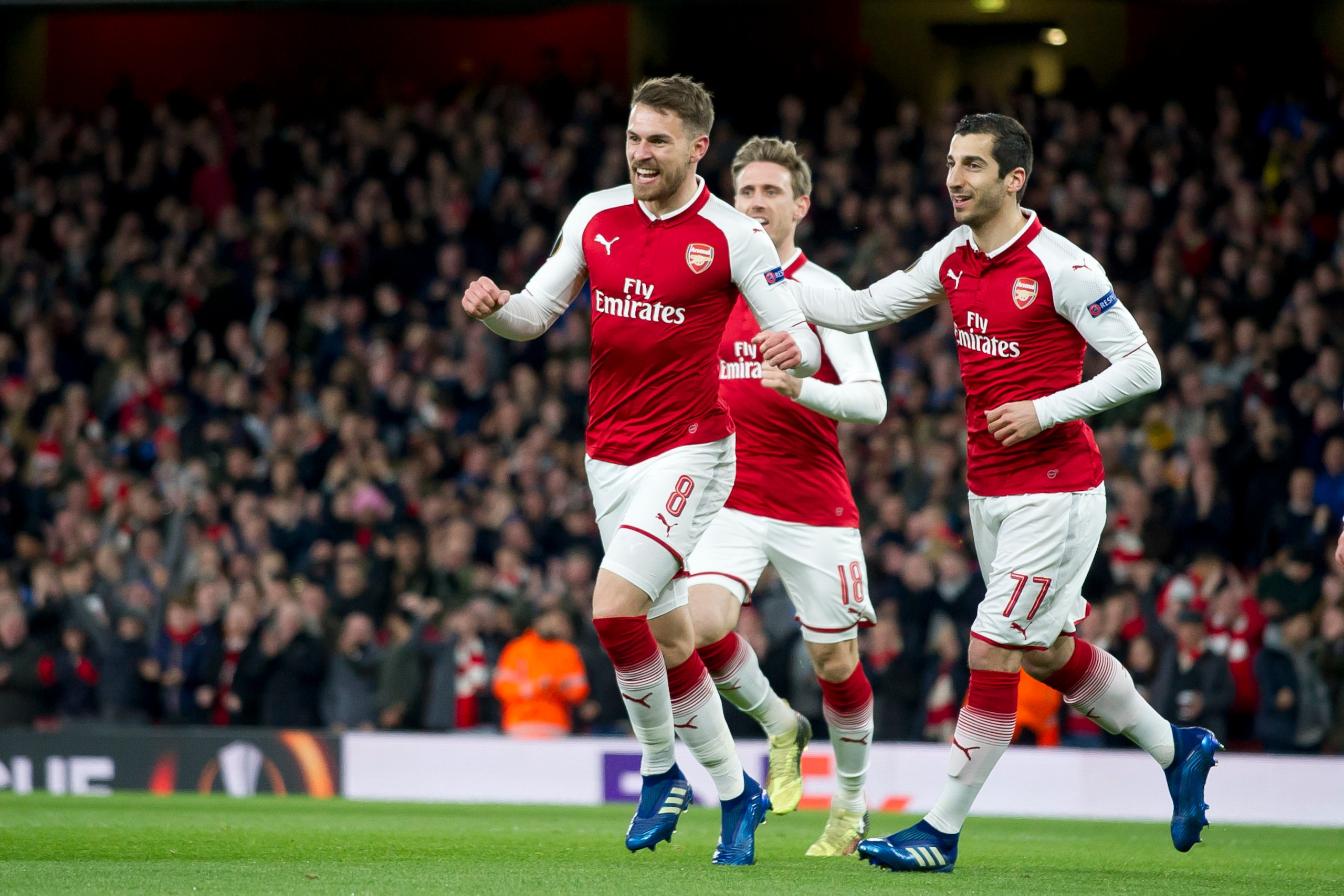 LONDON, ENGLAND - APRIL 05: Aaron Ramsey of Arsenal celebrates after scoring his team`s first goal with team mates Nacho Monreal of Arsenal and Henrikh Mkhitaryan of Arsenal during the UEFA UEFA Europa League Quarter-Final first leg match between Arsenal 