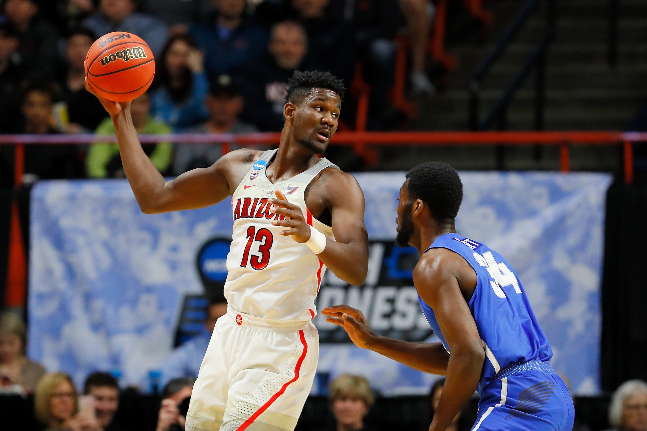 BOISE, ID - MARCH 15: Deandre Ayton #13 of the Arizona Wildcats handles the ball in the first half against Ikenna Smart #34 of the Buffalo Bulls during the first round of the 2018 NCAA Men's Basketball Tournament at Taco Bell Arena on March 15, 2018 in B BOISE, ID - MARCH 15: Deandre Ayton #13 of the Arizona Wildcats handles the ball in the first half against Ikenna Smart #34 of the Buffalo Bulls during the first round of the 2018 NCAA Men's Basketball Tournament at Taco Bell Arena on March 15, 2018 in B