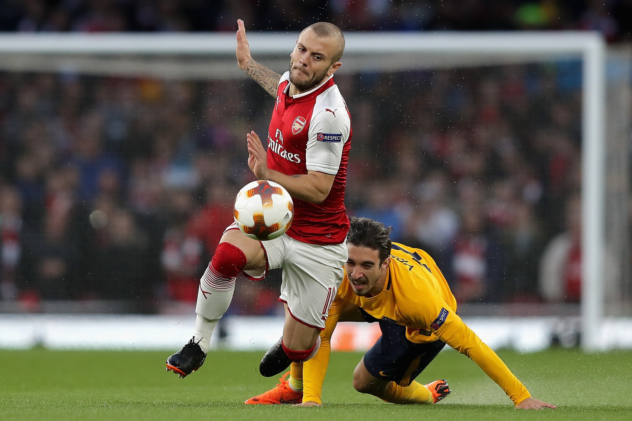 LONDON, ENGLAND - APRIL 26: Sime Vrsaljko of Atletico Madrid tackles Jack Wilshere of Arsenal during the UEFA Europa League Semi Final leg one match between Arsenal FC and Atletico Madrid at Emirates Stadium on April 26, 2018 in London, United Kingdom. LONDON, ENGLAND - APRIL 26: Sime Vrsaljko of Atletico Madrid tackles Jack Wilshere of Arsenal during the UEFA Europa League Semi Final leg one match between Arsenal FC and Atletico Madrid at Emirates Stadium on April 26, 2018 in London, United Kingdom.