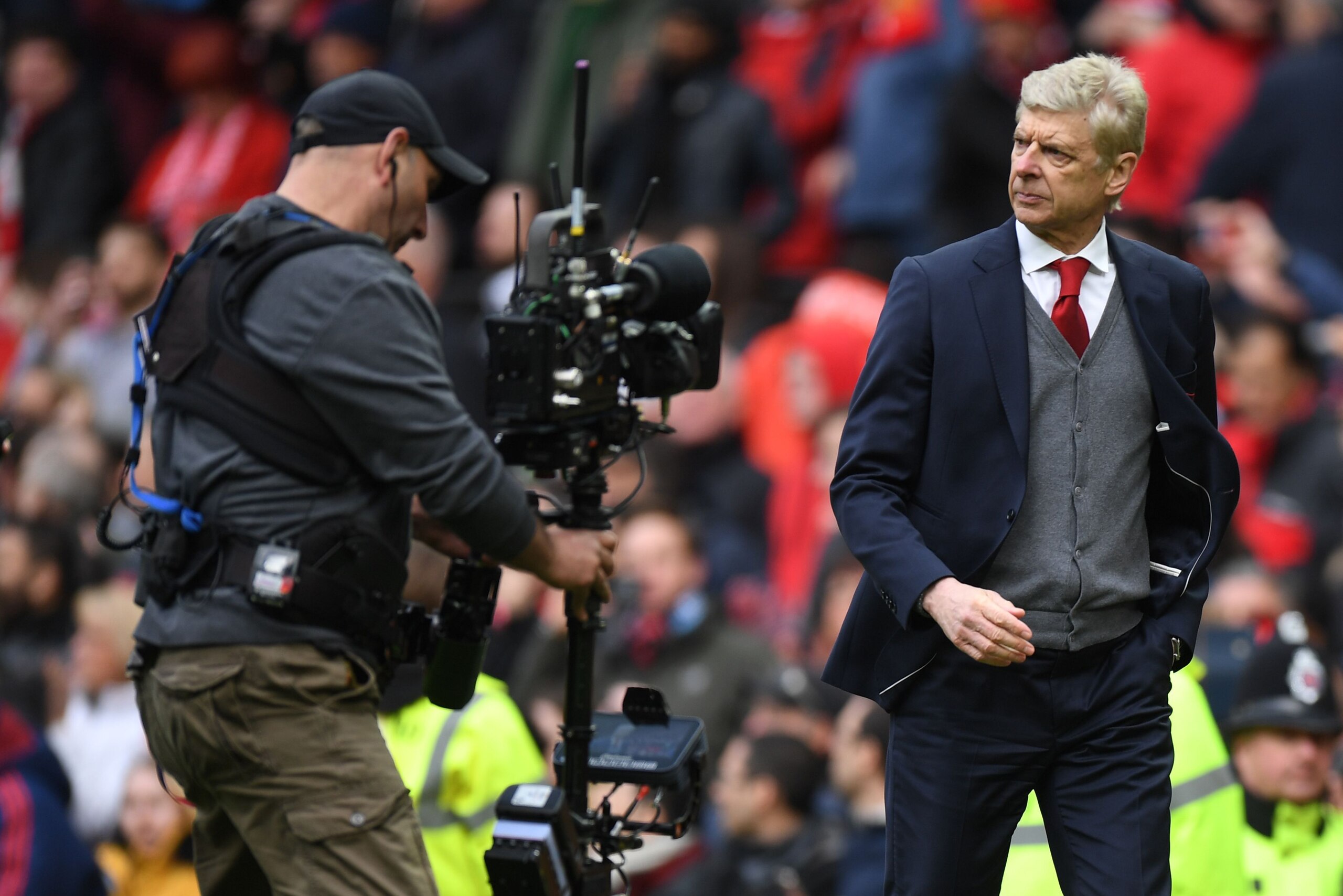 Arsenal's French manager Arsene Wenger (R) leaves the pitch after the English Premier League football match between Manchester United and Arsenal at Old Trafford in Manchester, north west England, on April 29, 2018. - Manchester United won the game 2-1. (