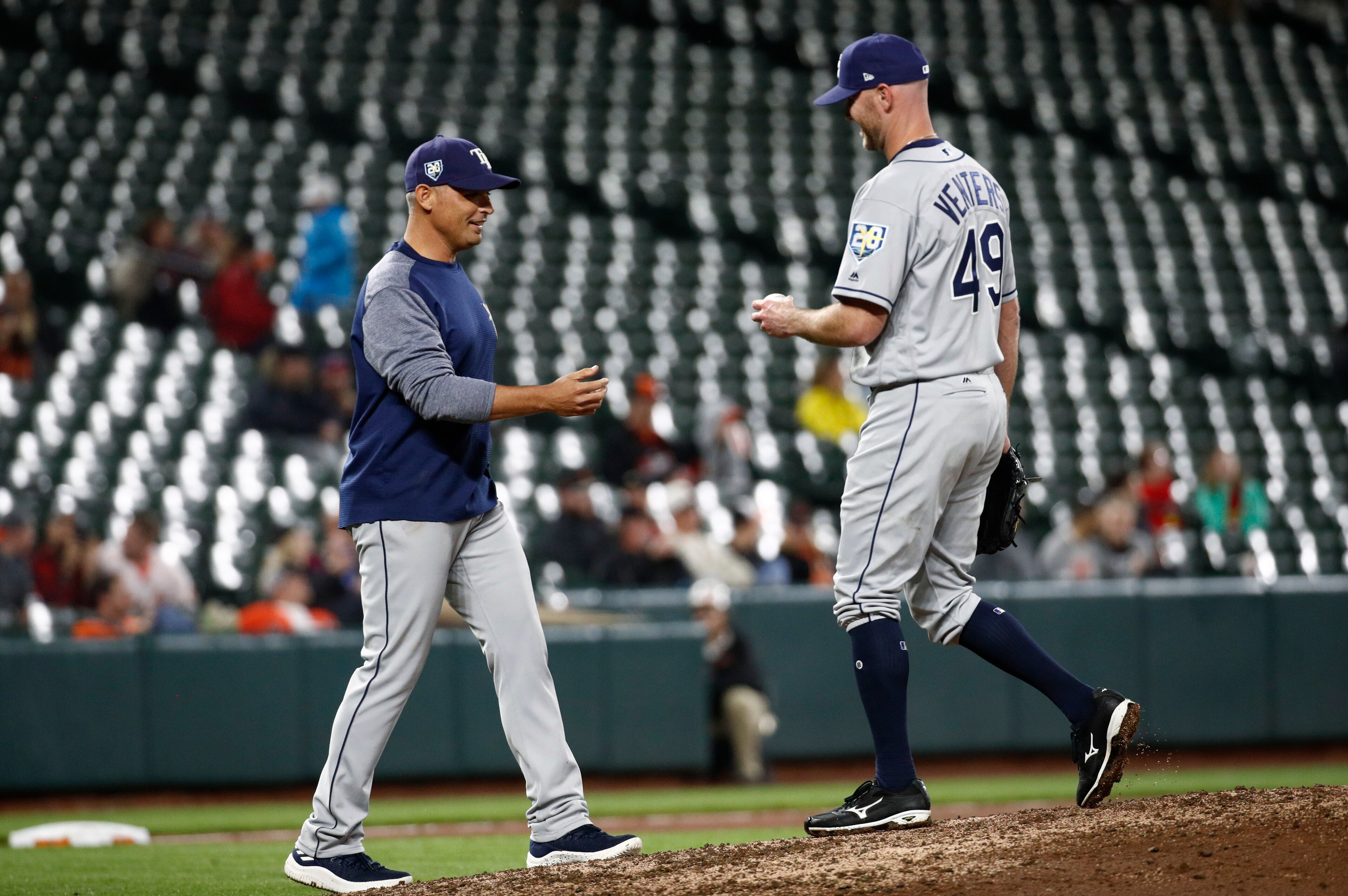 Jonny Venters hands the ball to Rays manager Kevin Cash after retiring Chris Davis.