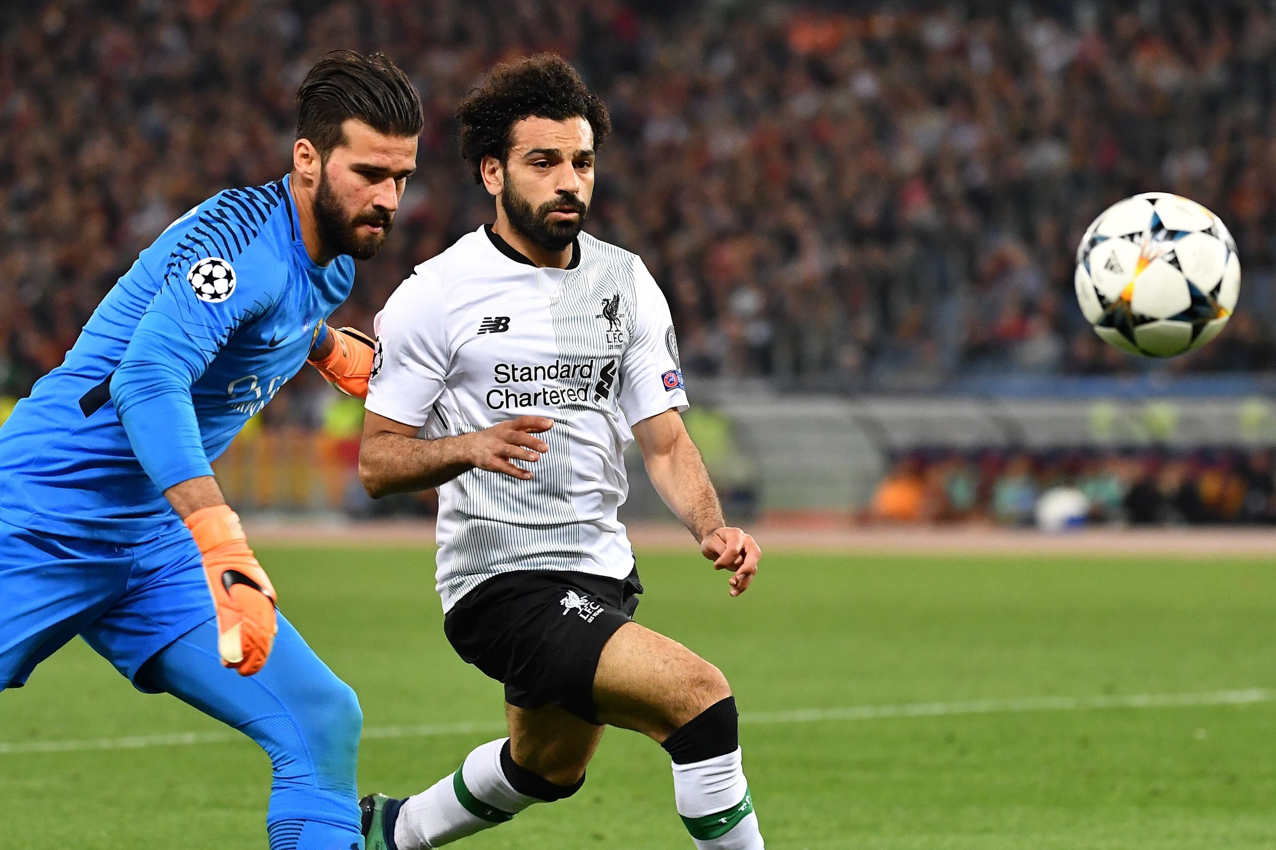 Roma's Brazilian goalkeeper Alisson (L) vies with Liverpool's Egyptian midfielder Mohamed Salah during the UEFA Champions League semi-final second leg football match AS Roma vs Liverpool FC at the Stadio Olimpico in Rome on May 2, 2018. (Photo by Alberto 