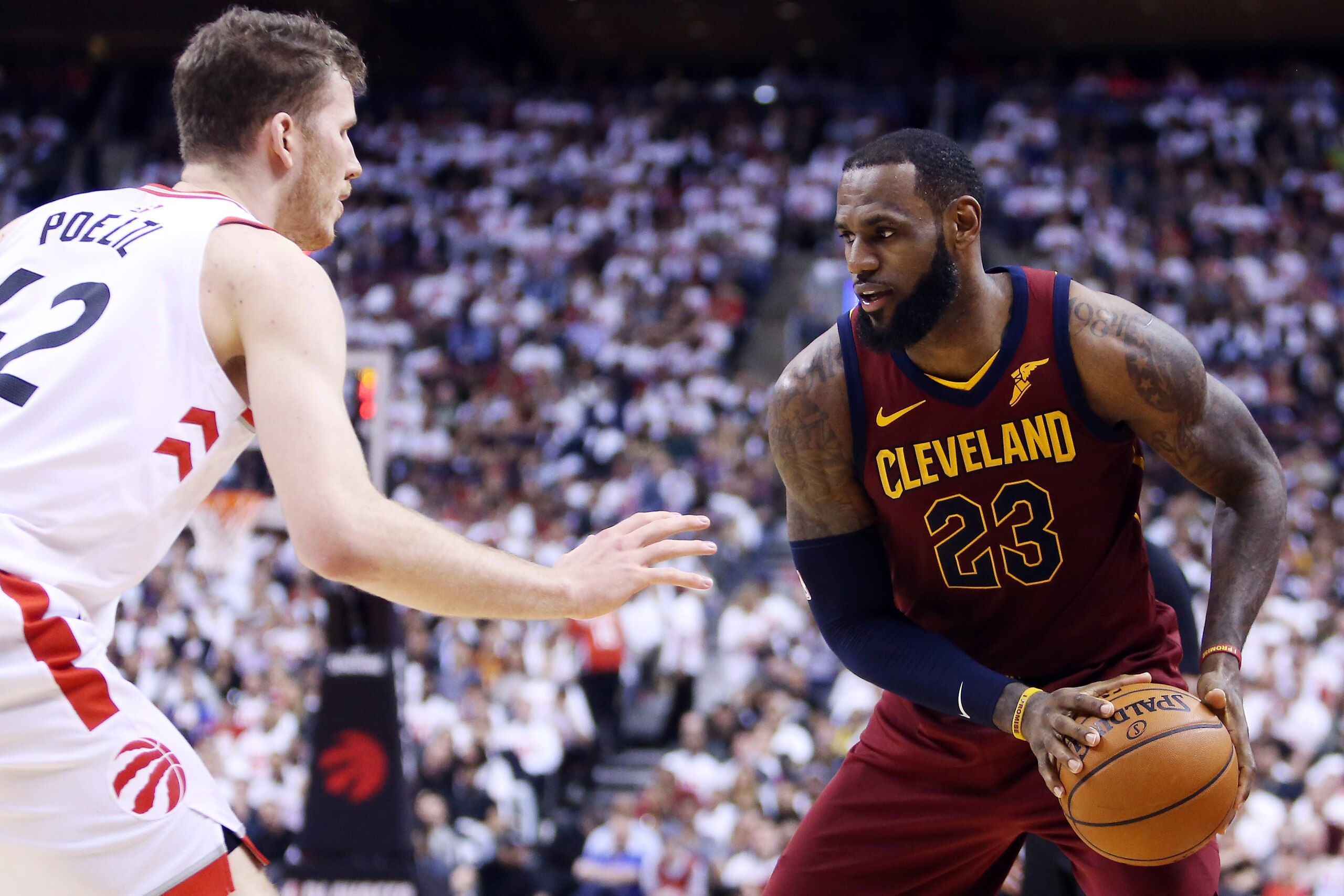 TORONTO, ON - MAY 01:  LeBron James #23 of the Cleveland Cavaliers dribbles the ball as Jakob Poeltl #42 of the Toronto Raptors defends in the second half of Game One of the Eastern Conference Semifinals during the 2018 NBA Playoffs at Air Canada Centre o