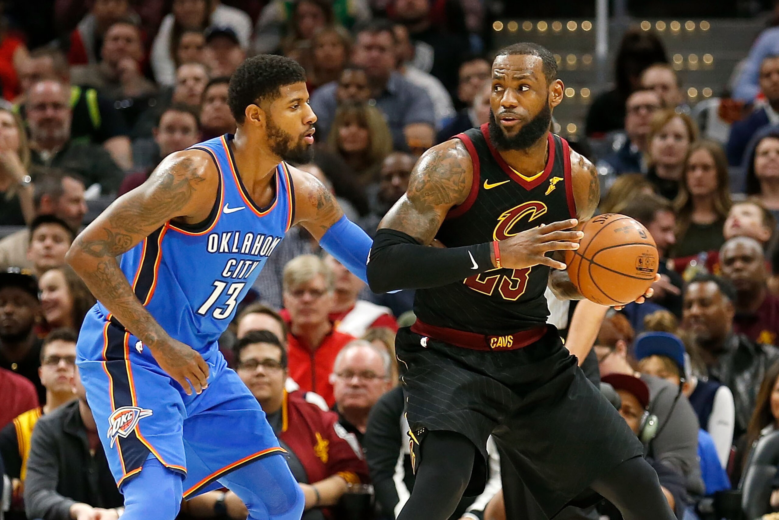 CLEVELAND, OH - JANUARY 20:  Paul George #13 of the Oklahoma City Thunder defends against LeBron James #23 of the Cleveland Cavaliers during the game at Quicken Loans Arena on January 20, 2018 in Cleveland, Ohio. NOTE TO USER: User expressly acknowledges 