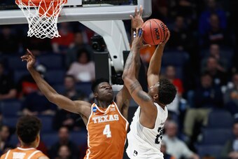 NASHVILLE, TN - MARCH 16:  Mohamed Bamba #4 of the Texas Longhorns blocks a shot by Jordan Caroline #24 of the Nevada Wolf Pack during the game in the first round of the 2018 NCAA Men's Basketball Tournament at Bridgestone Arena on March 16, 2018 in Nashv