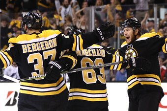BOSTON, MA - MAY 2: Patrice Bergeron #37 of the Boston Bruins celebrates with Brad Marchand #63 and David Pastrnak #88 after scoring a goal against the Tampa Bay Lightning during the first period Game Three of the Eastern Conference Second Round during th