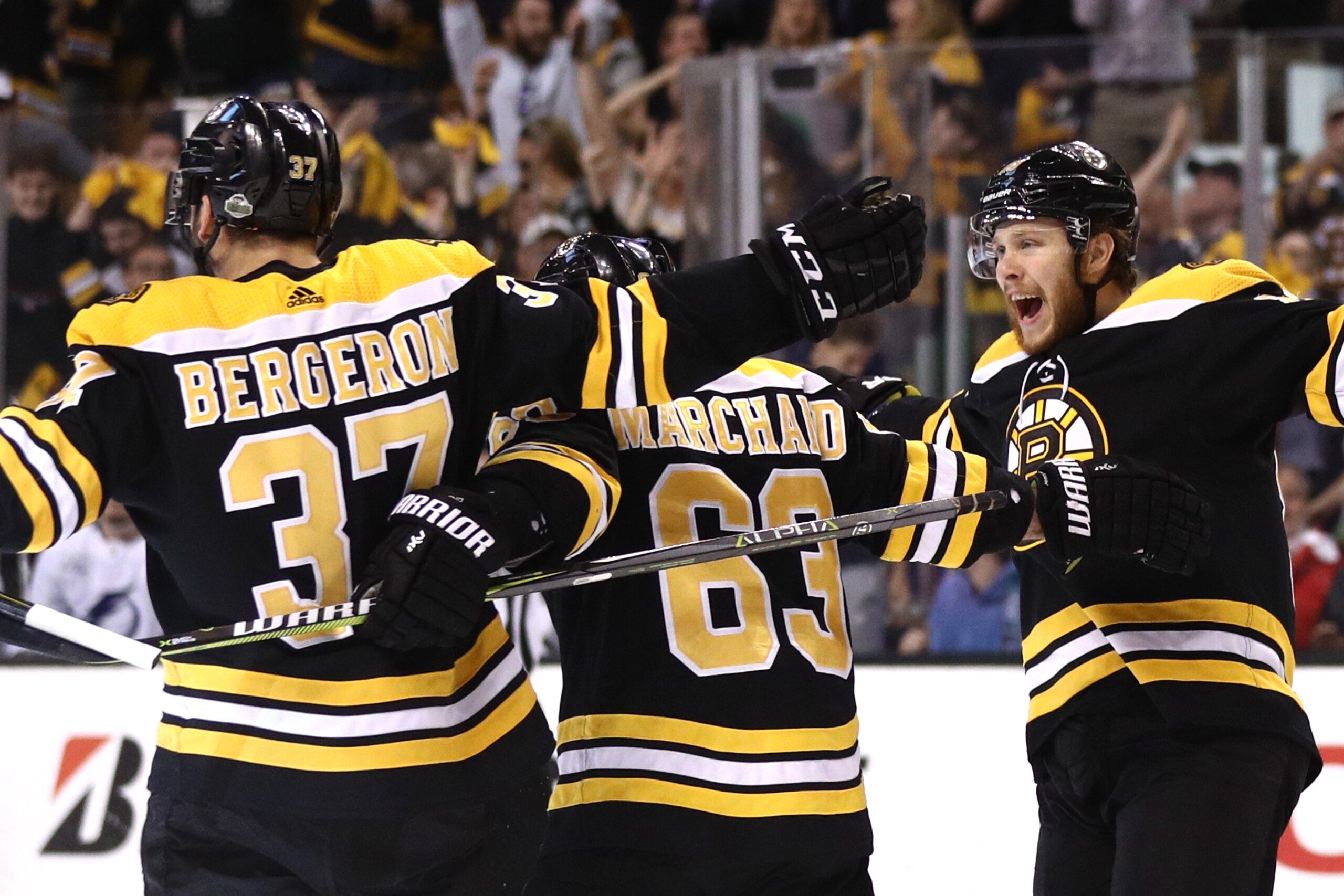 BOSTON, MA - MAY 2: Patrice Bergeron #37 of the Boston Bruins celebrates with Brad Marchand #63 and David Pastrnak #88 after scoring a goal against the Tampa Bay Lightning during the first period Game Three of the Eastern Conference Second Round during th