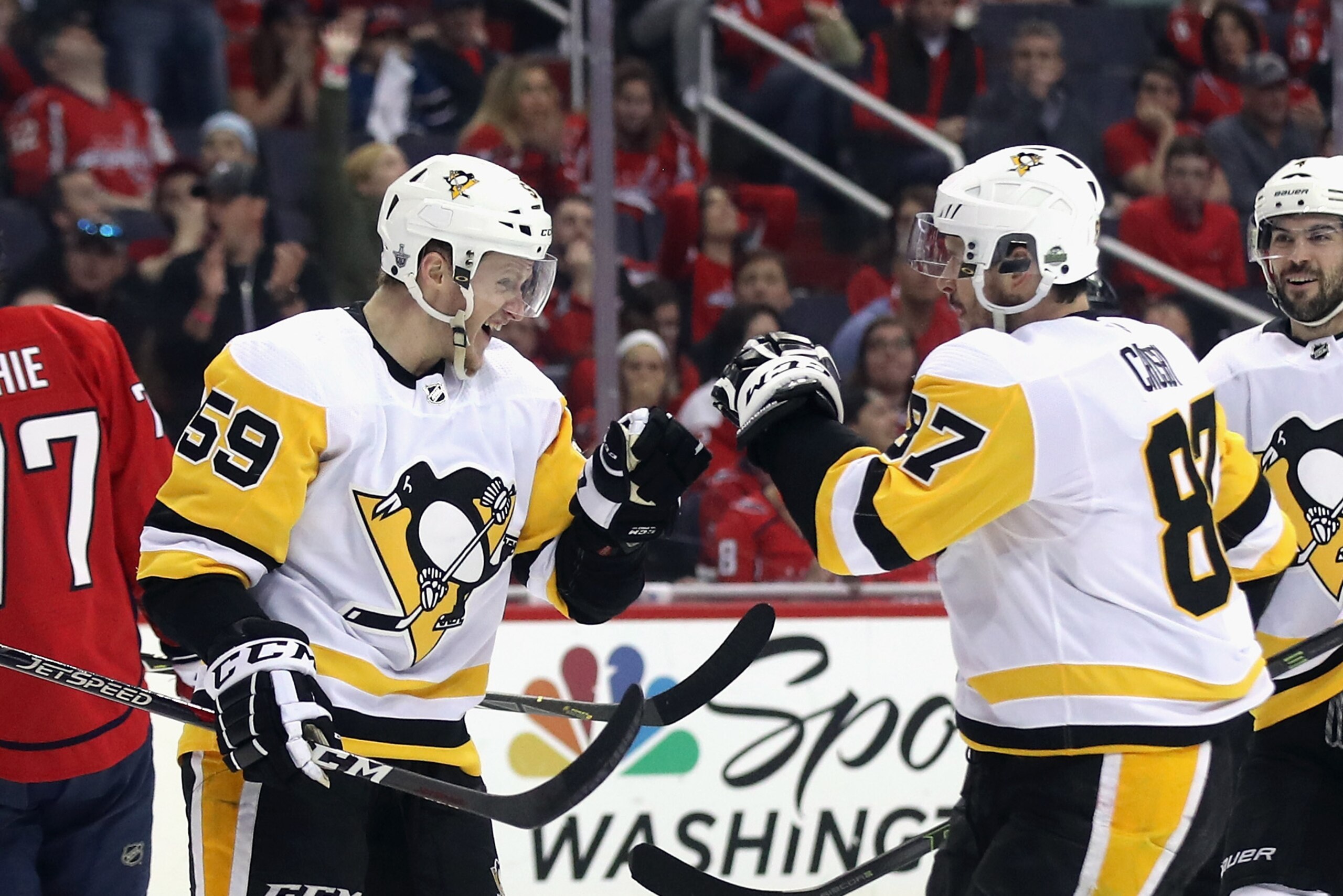 WASHINGTON, DC - APRIL 26:  Jake Guentzel #59 of the Pittsburgh Penguins (l) celebrates his game winning goal at 7:48 of the third period against the Washington Capitals and is joined by Sidney Crosby #87 (r) in Game One of the Eastern Conference Second R