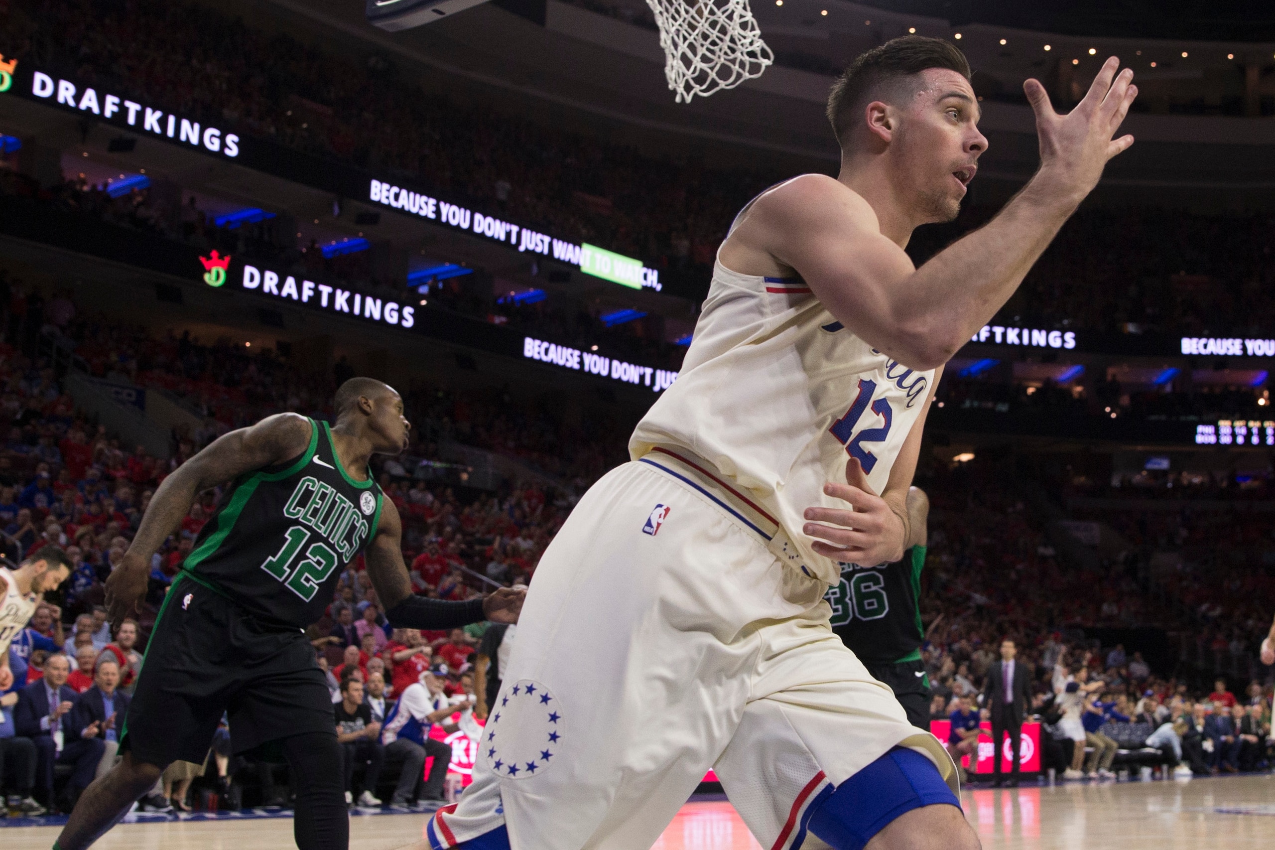 PHILADELPHIA, PA - MAY 7: T.J. McConnell #12 of the Philadelphia 76ers reacts in front of Terry Rozier #12 of the Boston Celtics after making a lay up in the third quarter during Game Four of the Eastern Conference Second Round of the 2018 NBA Playoffs at