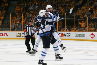NASHVILLE, TN - MAY 05:  Brandon Tanev #13 of the Winnipeg Jets jumps into the arms of teammate Dustin Byfuglien #33 to congratulate him on scoring a goal against the Nashville Predators during the second period of Game Five of the Western Conference Seco