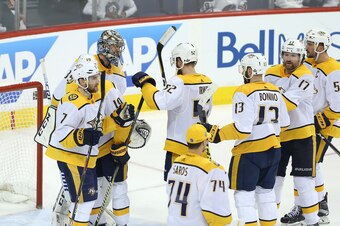 WINNIPEG, MANITOBA - MAY 7: Teammates congratulate Pekka Rinne #35 of the Nashville Predators after defeating the Winnipeg Jets in Game Six of the Western Conference Second Round during the 2018 NHL Stanley Cup Playoffs on May 7, 2018 at Bell MTS Place in