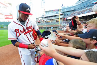 ATLANTA, GA - MAY 4: Ronald Acuna, Jr. #13 of the Atlanta Braves signs autographs before the game against the San Francisco Giants at SunTrust Park on May 4, 2018 in Atlanta, Georgia. (Photo by Scott Cunningham/Getty Images)