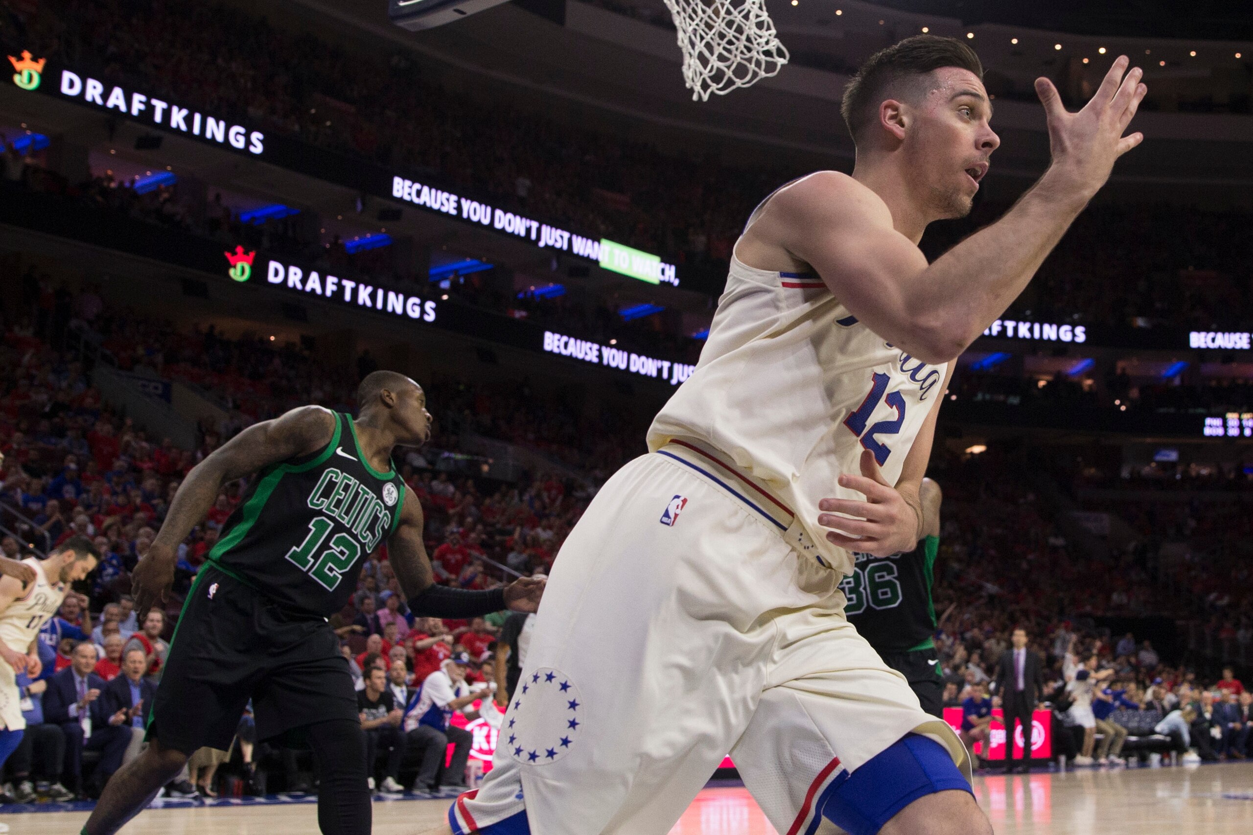 PHILADELPHIA, PA - MAY 7: T.J. McConnell #12 of the Philadelphia 76ers reacts in front of Terry Rozier #12 of the Boston Celtics after making a lay up in the third quarter during Game Four of the Eastern Conference Second Round of the 2018 NBA Playoffs at