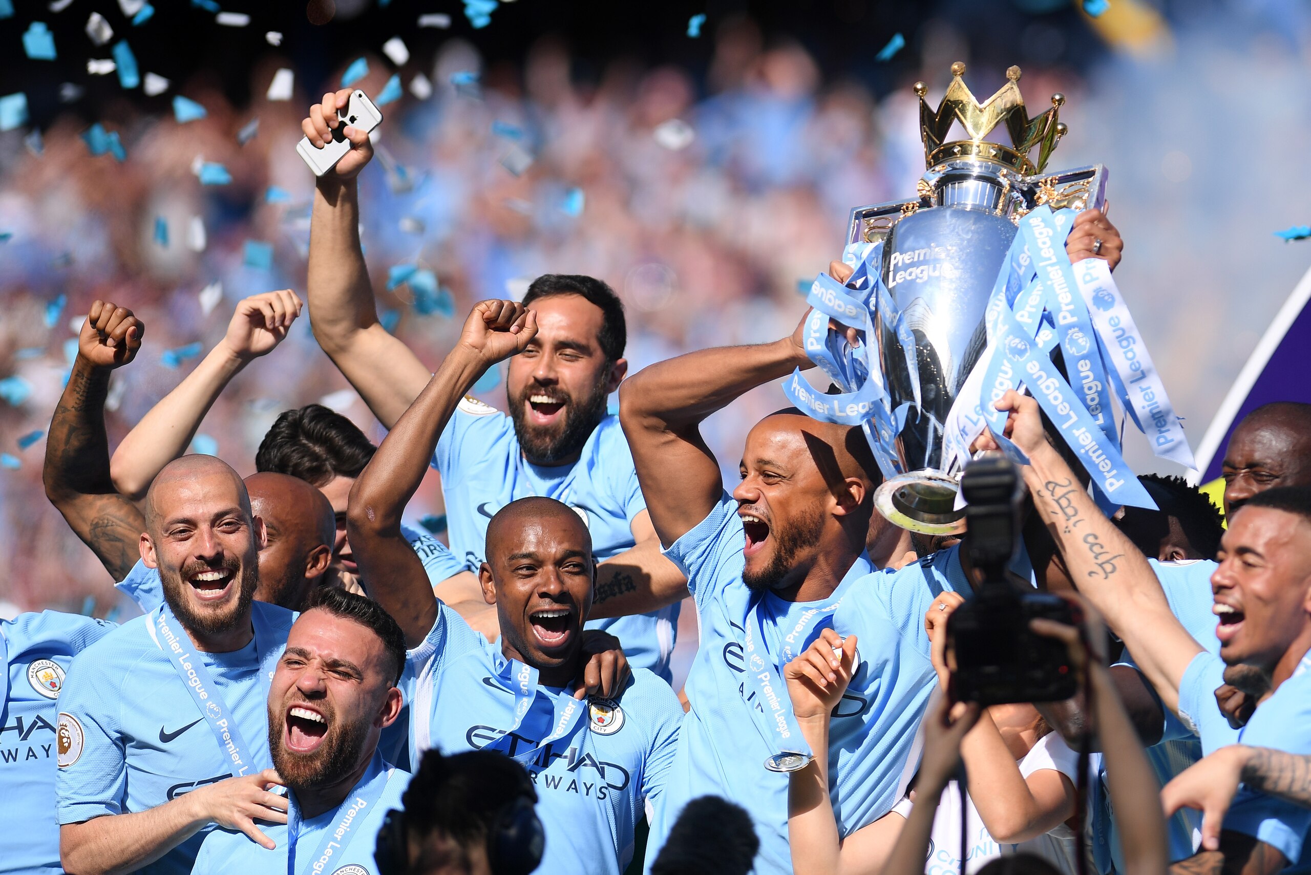 MANCHESTER, ENGLAND - MAY 06:  Vincent Kompany of Manchester City lifts the Premier League Trophy alongside David Silva, Nicolas Otamendi and Fernandinho as Manchester City celebrate winning the Premier League Title during the Premier League match between