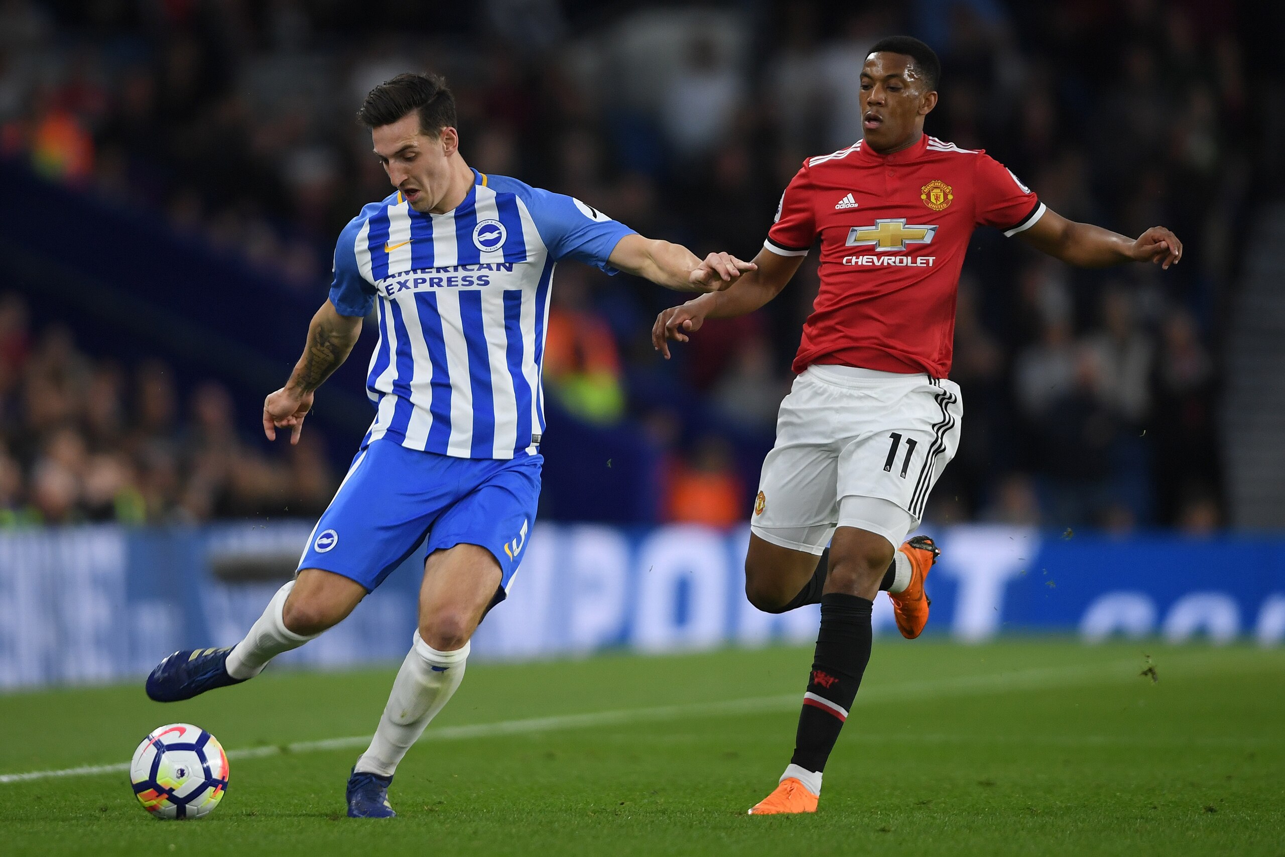 BRIGHTON, ENGLAND - MAY 04:  Lewis Dunk of Brighton & Hove Albionis challenged by Anthony Martial of Manchester United during the Premier League match between Brighton and Hove Albion and Manchester United at Amex Stadium on May 4, 2018 in Brighton, Engla