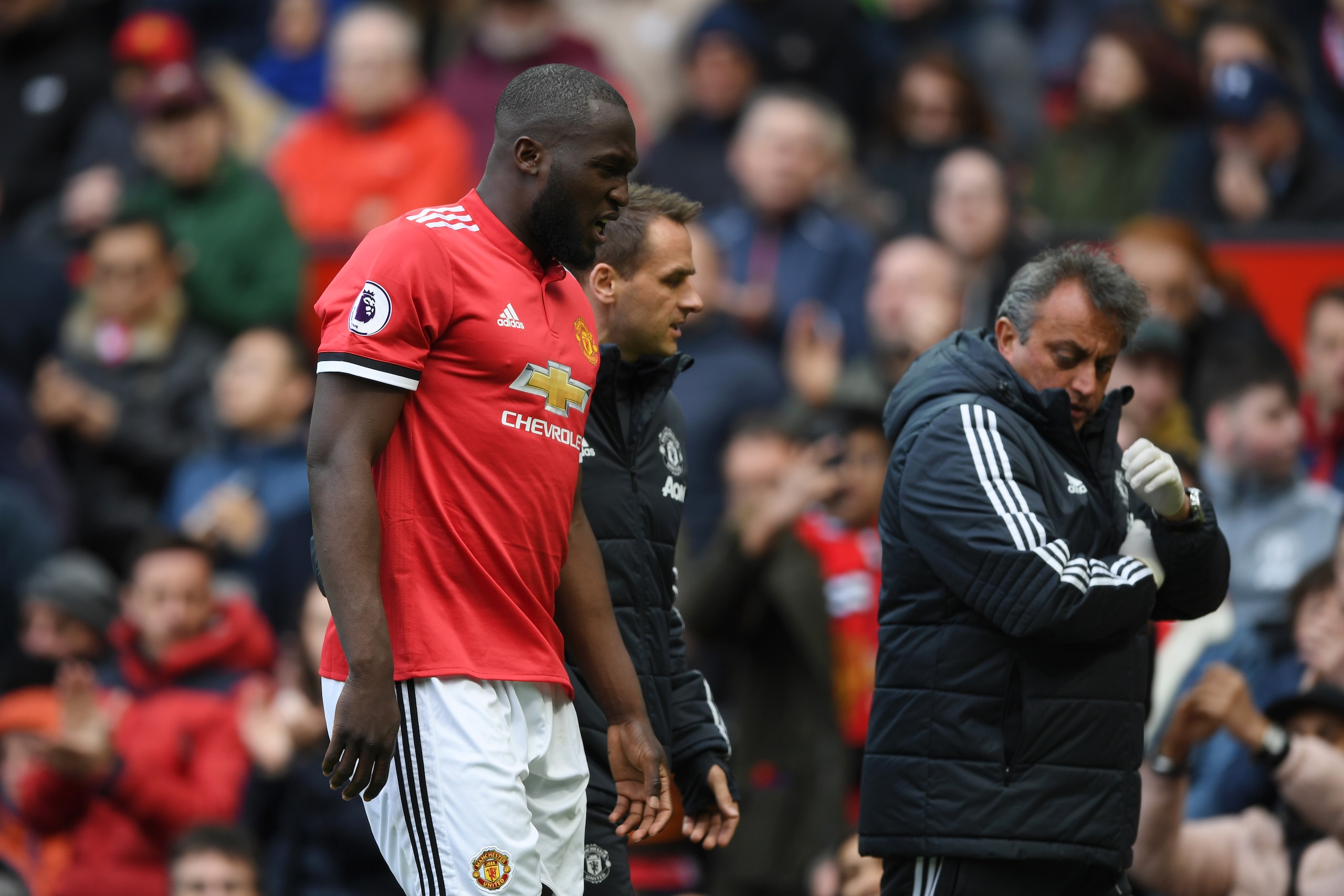 MANCHESTER, ENGLAND - APRIL 29: Romelu Lukaku of Manchester United is taken off injured during the Premier League match between Manchester United and Arsenal at Old Trafford on April 29, 2018 in Manchester, England.  (Photo by Shaun Botterill/Getty Images