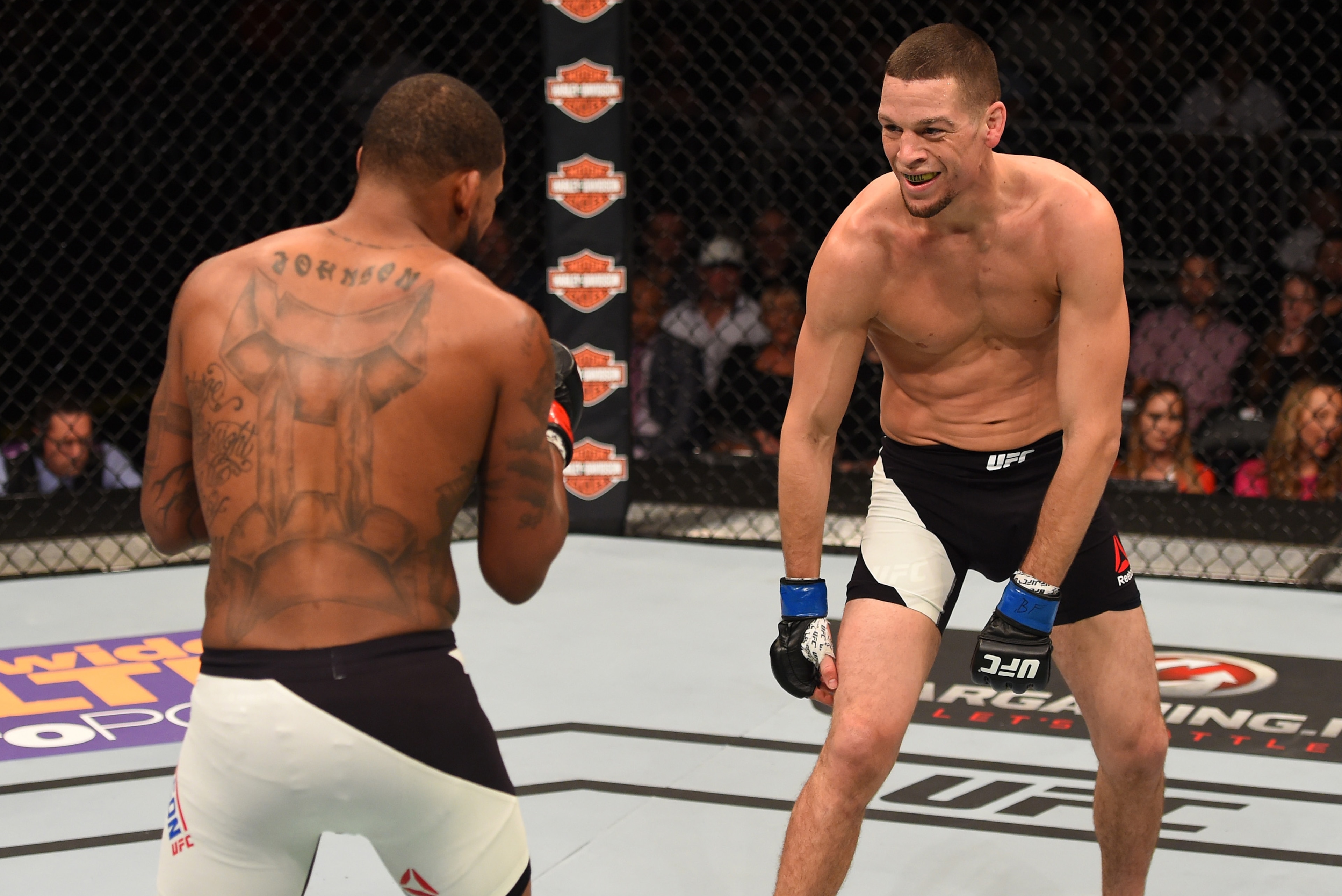ORLANDO, FL - DECEMBER 19:   (R-L) Nate Diaz taunts Michael Johnson in their lightweight bout during the UFC Fight Night event at the Amway Center on December 19, 2015 in Orlando, Florida. (Photo by Josh Hedges/Zuffa LLC/Zuffa LLC via Getty Images)