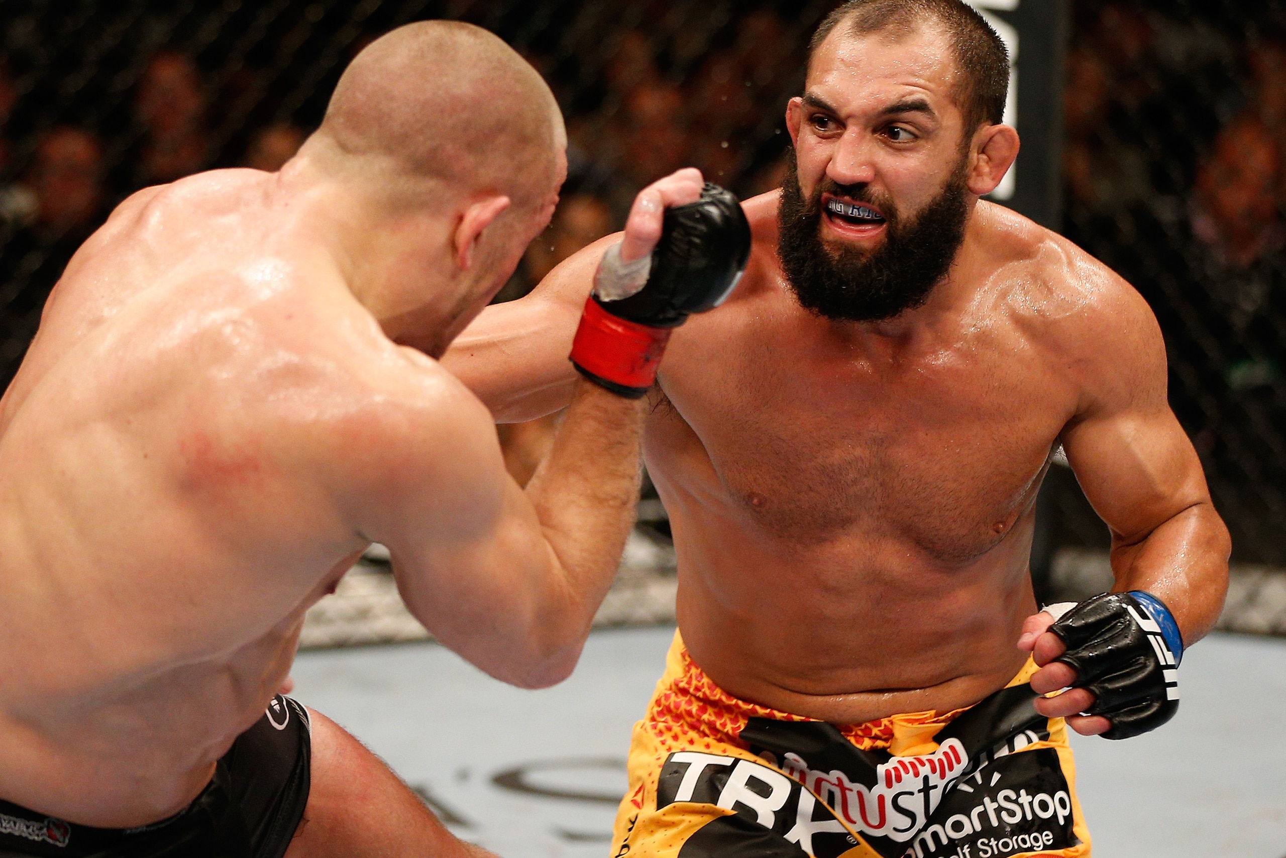 LAS VEGAS, NV - NOVEMBER 16:  (R-L) Johny Hendricks punches Georges St-Pierre in their UFC welterweight championship bout during the UFC 167 event inside the MGM Grand Garden Arena on November 16, 2013 in Las Vegas, Nevada. (Photo by Josh Hedges/Zuffa LLC
