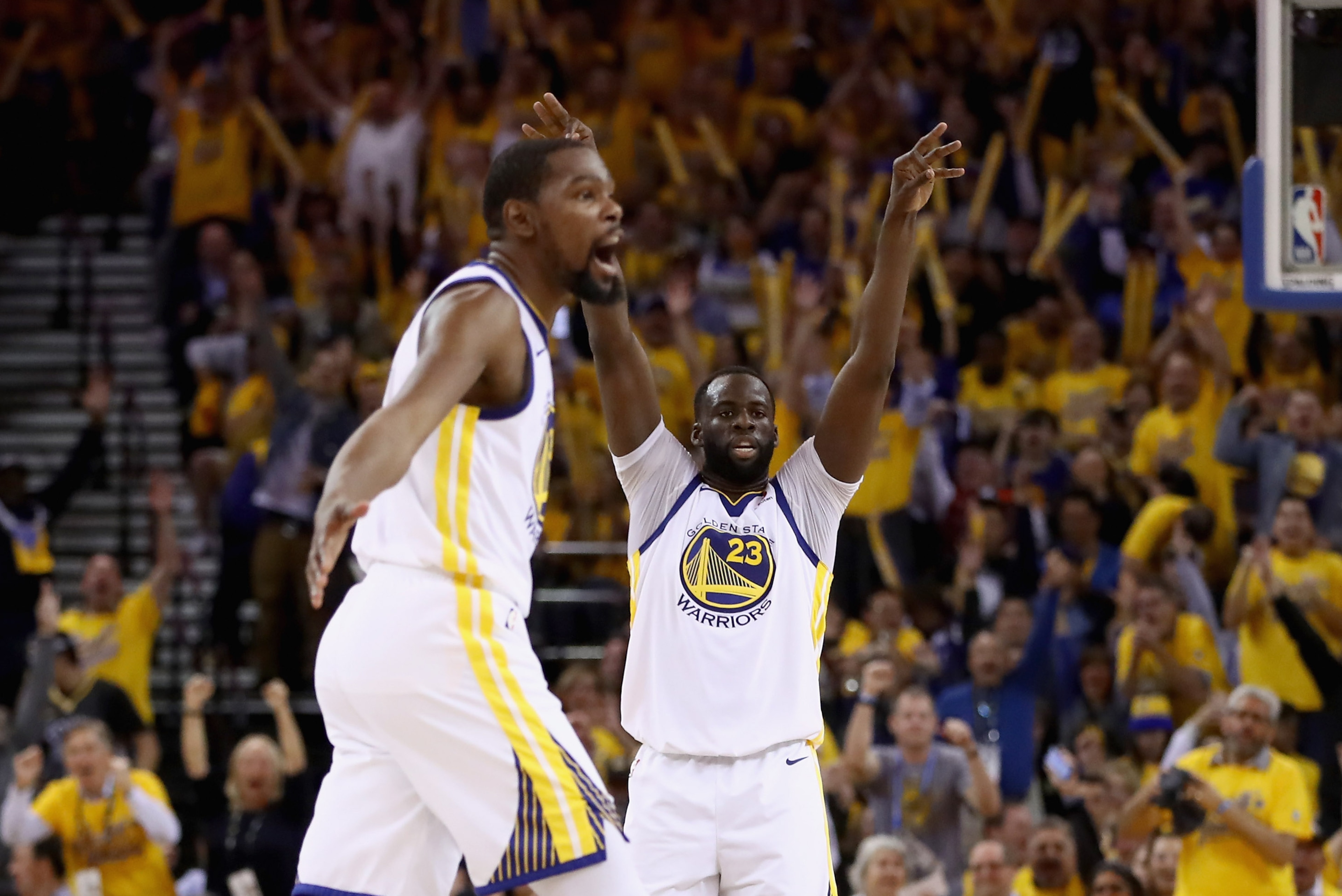 OAKLAND, CA - MAY 08:  Kevin Durant #35 of the Golden State Warriors and Draymond Green #23 react after Stephen Curry #30 made a shot against the New Orleans Pelicans during Game Five of the Western Conference Semifinals of the 2018 NBA Playoffs at ORACLE