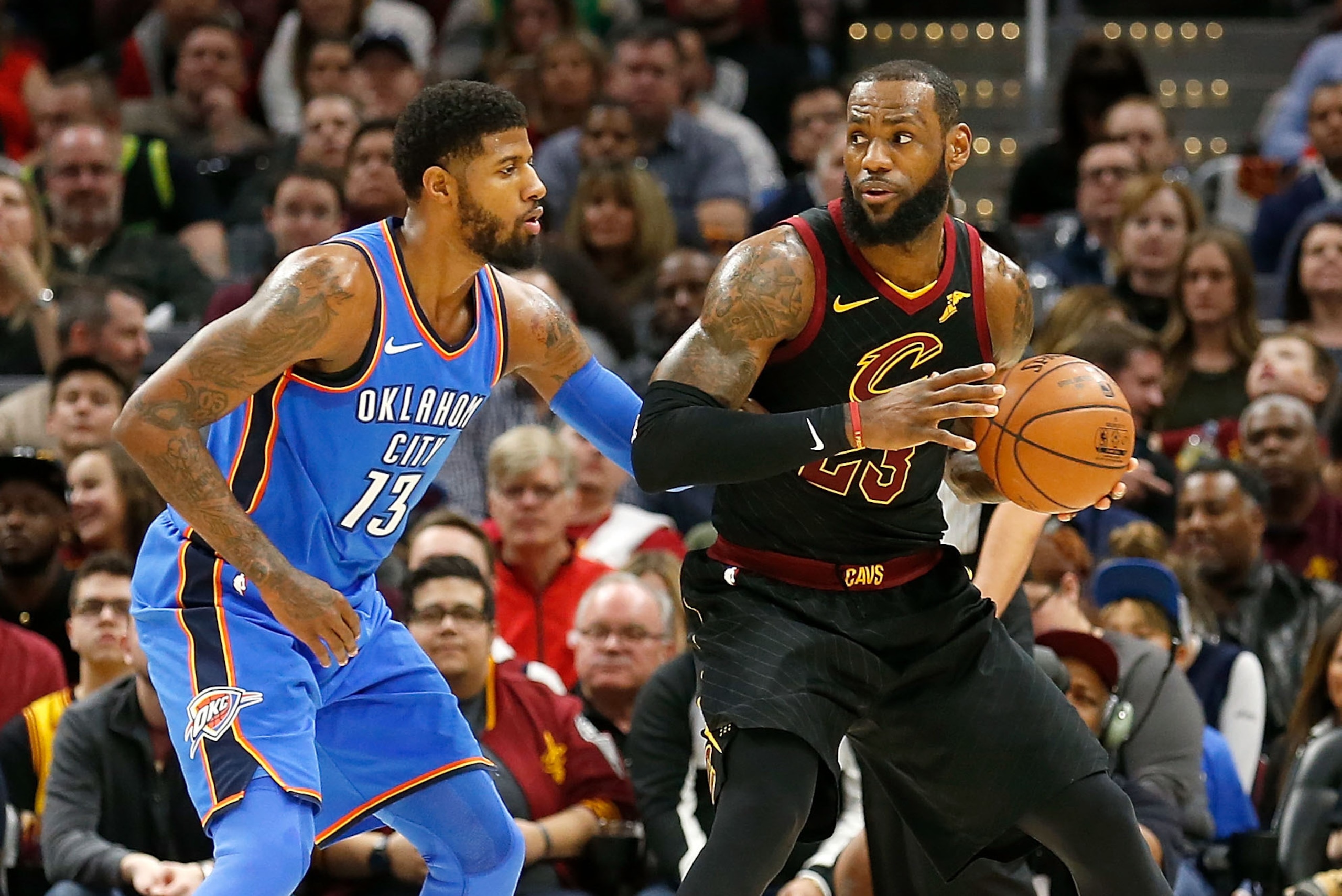 CLEVELAND, OH - JANUARY 20:  Paul George #13 of the Oklahoma City Thunder defends against LeBron James #23 of the Cleveland Cavaliers during the game at Quicken Loans Arena on January 20, 2018 in Cleveland, Ohio. NOTE TO USER: User expressly acknowledges 