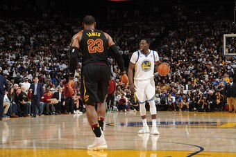 OAKLAND, CA - DECEMBER 25:   Draymond Green #23 of the Golden State Warriors handles the ball against LeBron James #23 of the Cleveland Cavaliers on December 25, 2017 at ORACLE Arena in Oakland, California. NOTE TO USER: User expressly acknowledges and ag