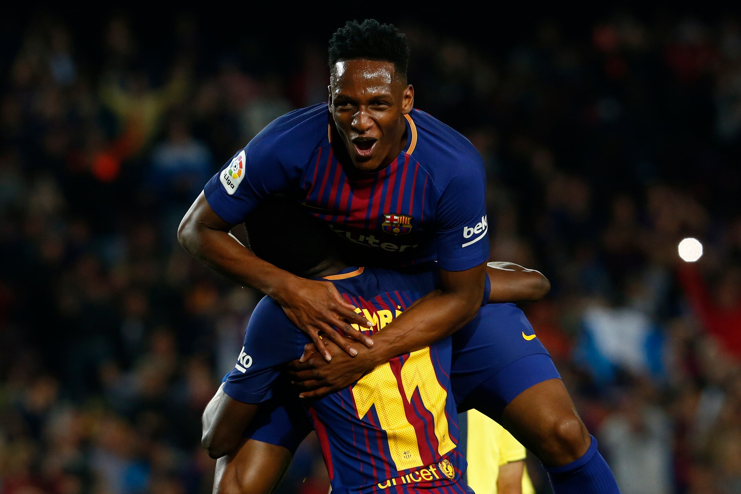 Barcelona's Colombian defender Yerry Mina celebrates a goal with Barcelona's French forward Ousmane Dembele (bottom) after scoring a goal during the Spanish league football match between Barcelona and Villarreal at the Camp Nou Stadium in Barcelona on May