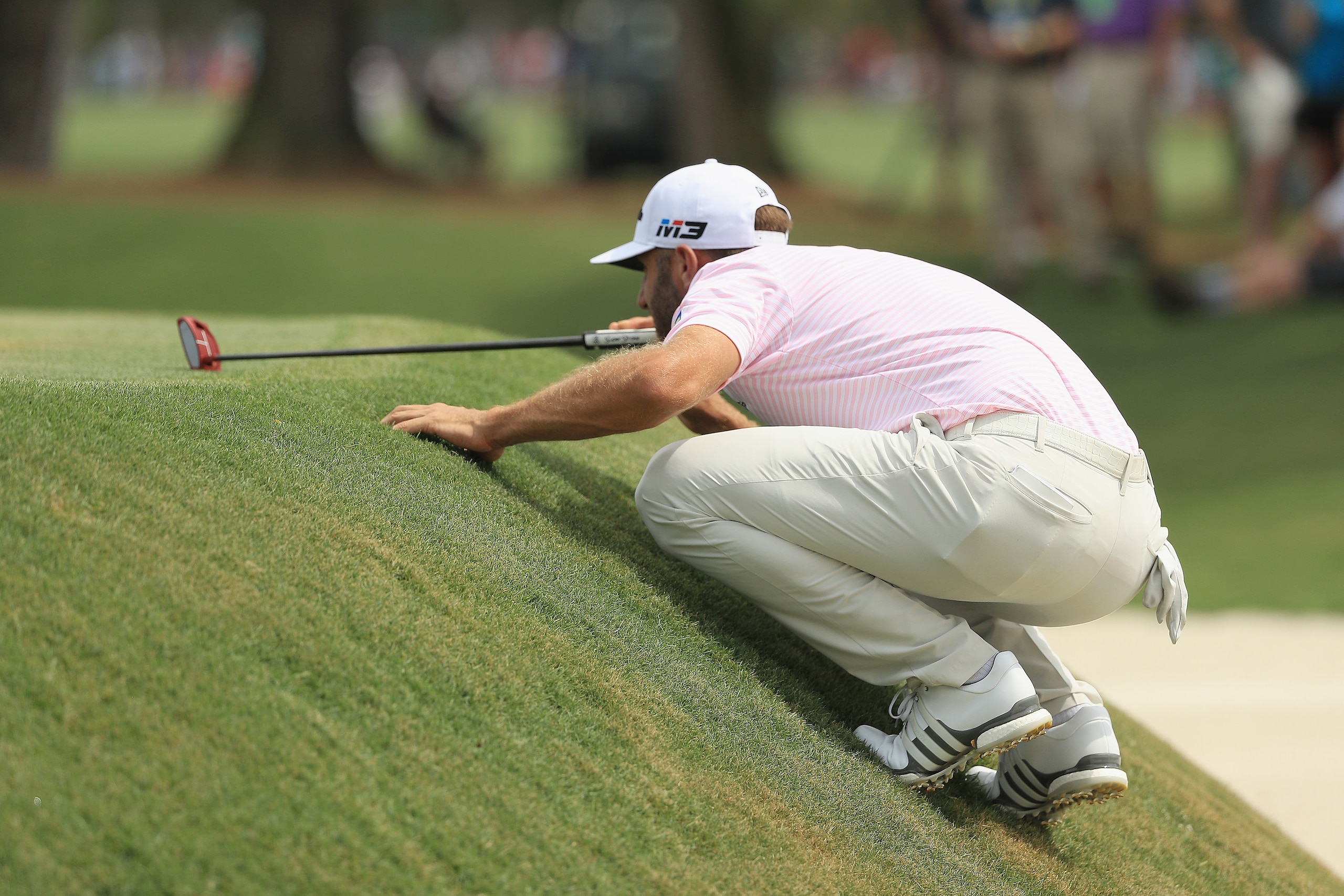 PONTE VEDRA BEACH, FL - MAY 12:  Dustin Johnson of the United States lines up a putt on the ninth green during the third round of THE PLAYERS Championship on the Stadium Course at TPC Sawgrass on May 12, 2018 in Ponte Vedra Beach, Florida.  (Photo by Mike