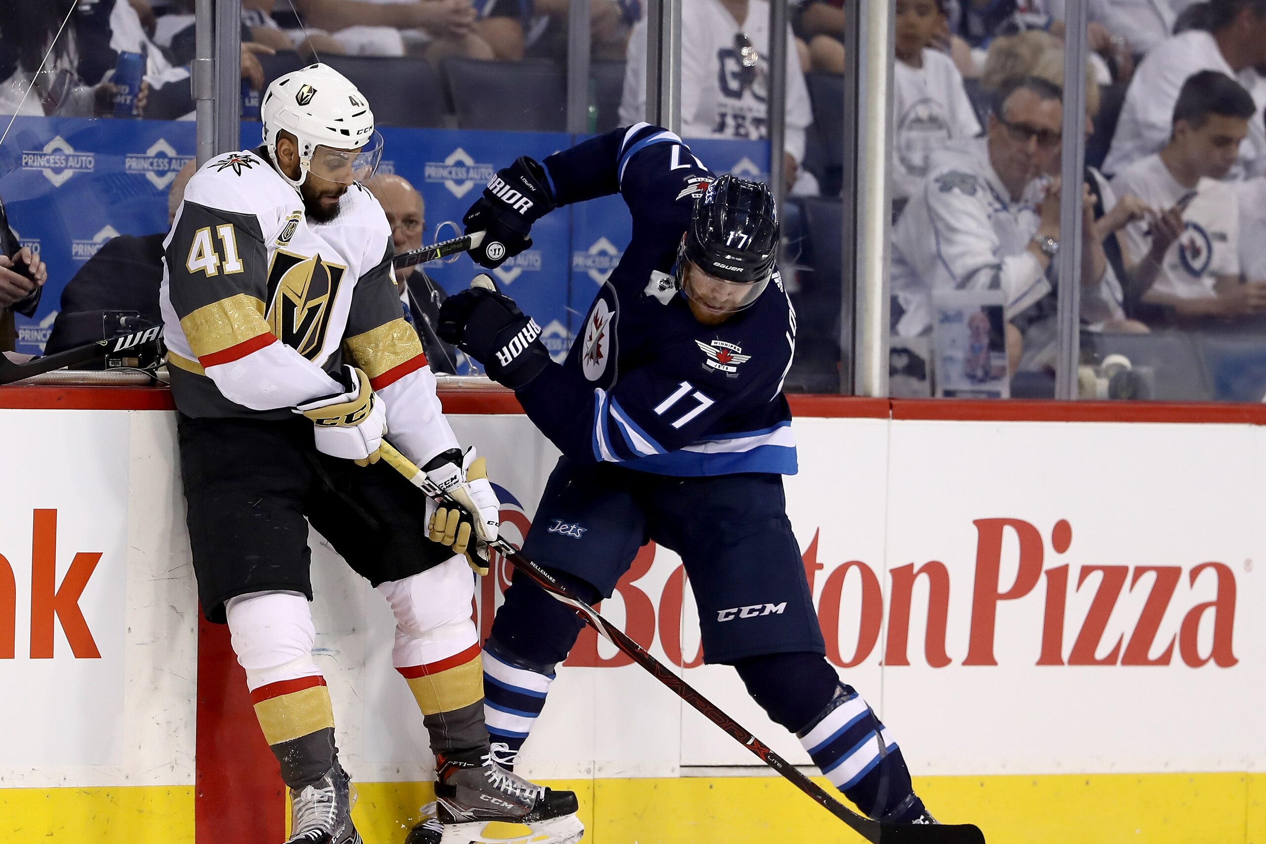 WINNIPEG, MB - MAY 12:  Pierre-Edouard Bellemare #41 of the Vegas Golden Knights and Adam Lowry #17 of the Winnipeg Jets fight for the puck in Game One of the Western Conference Finals during the 2018 NHL Stanley Cup Playoffs at Bell MTS Place on May 12, 
