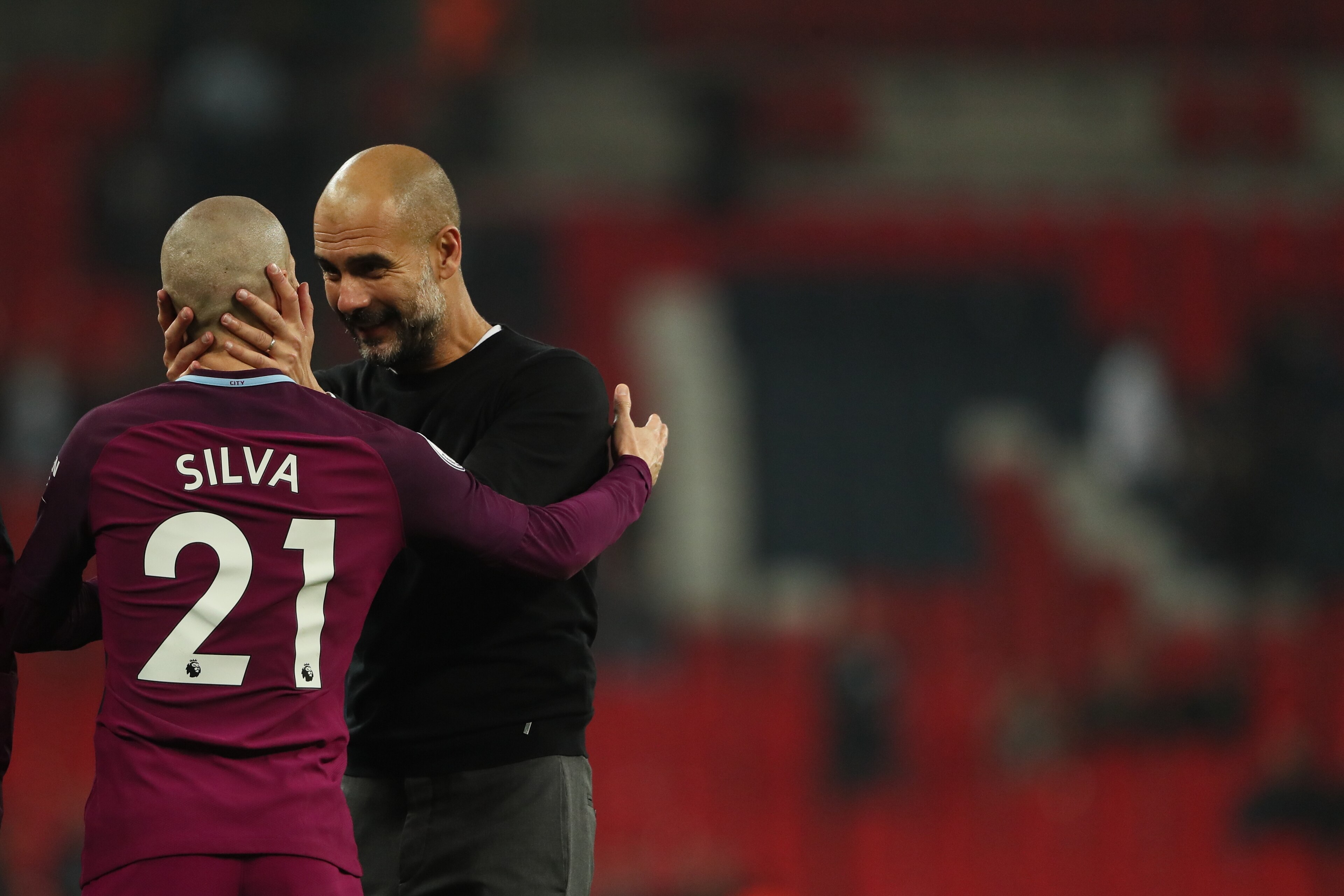 LONDON, ENGLAND - APRIL 14: David Silva of Manchester City and Manchester City manager Pep Guardiola during the Premier League match between Tottenham Hotspur and Manchester City at Wembley Stadium on April 14, 2018 in London, England. (Photo by Matthew A