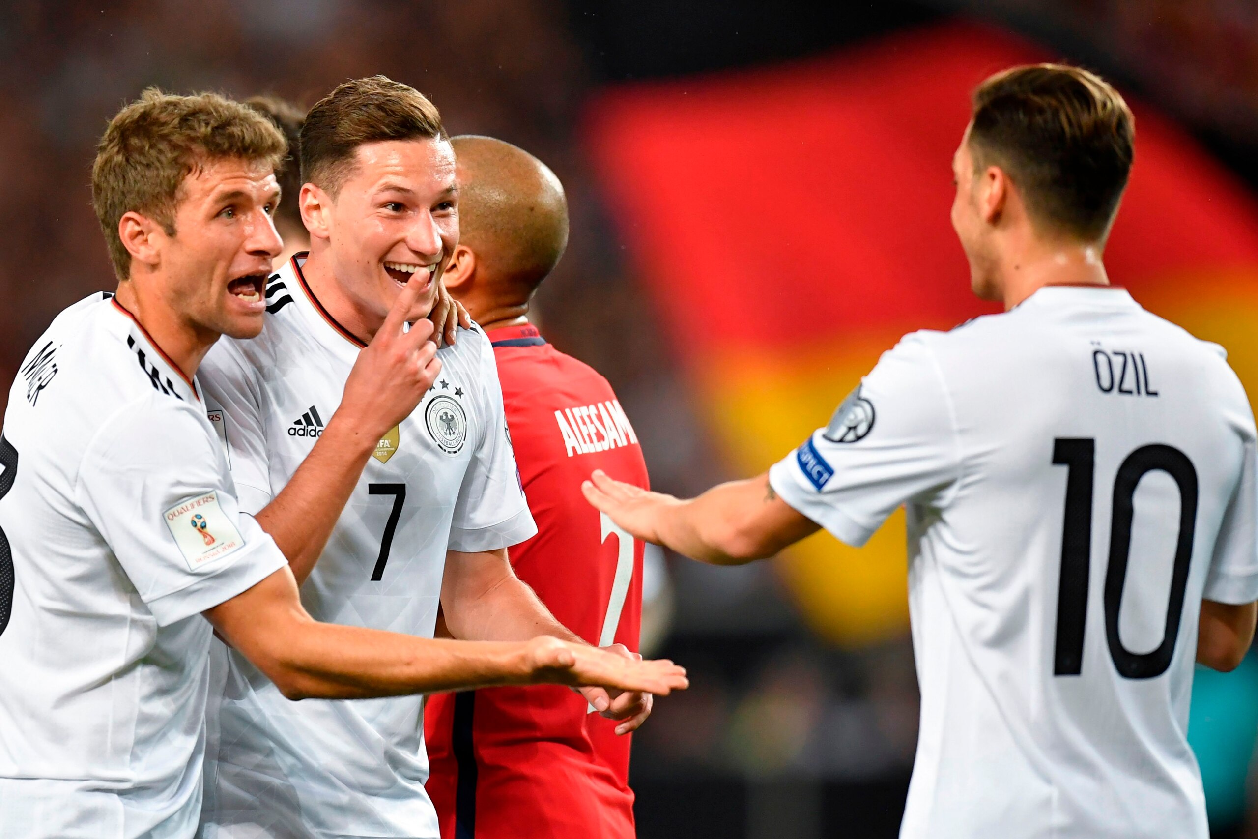 Germany's midfielder Julian Draxler (2nd,L) celebrates scoring his side's second goal with teammates Germany's midfielder Thomas Mueller (L) and Germany's midfielder Mesut Ozil during the FIFA World Cup 2018 qualification match between Germany and Norway 