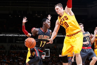 CINCINNATI, OH - OCTOBER 7: Dennis Schroder #17 of the Atlanta Hawks drives to the basket against Timofey Mozgov #20 of the Cleveland Cavaliers during a preseason game at Cintas Center on October 7, 2015 in Cincinnati, Ohio. The Hawks defeated the Cavalie