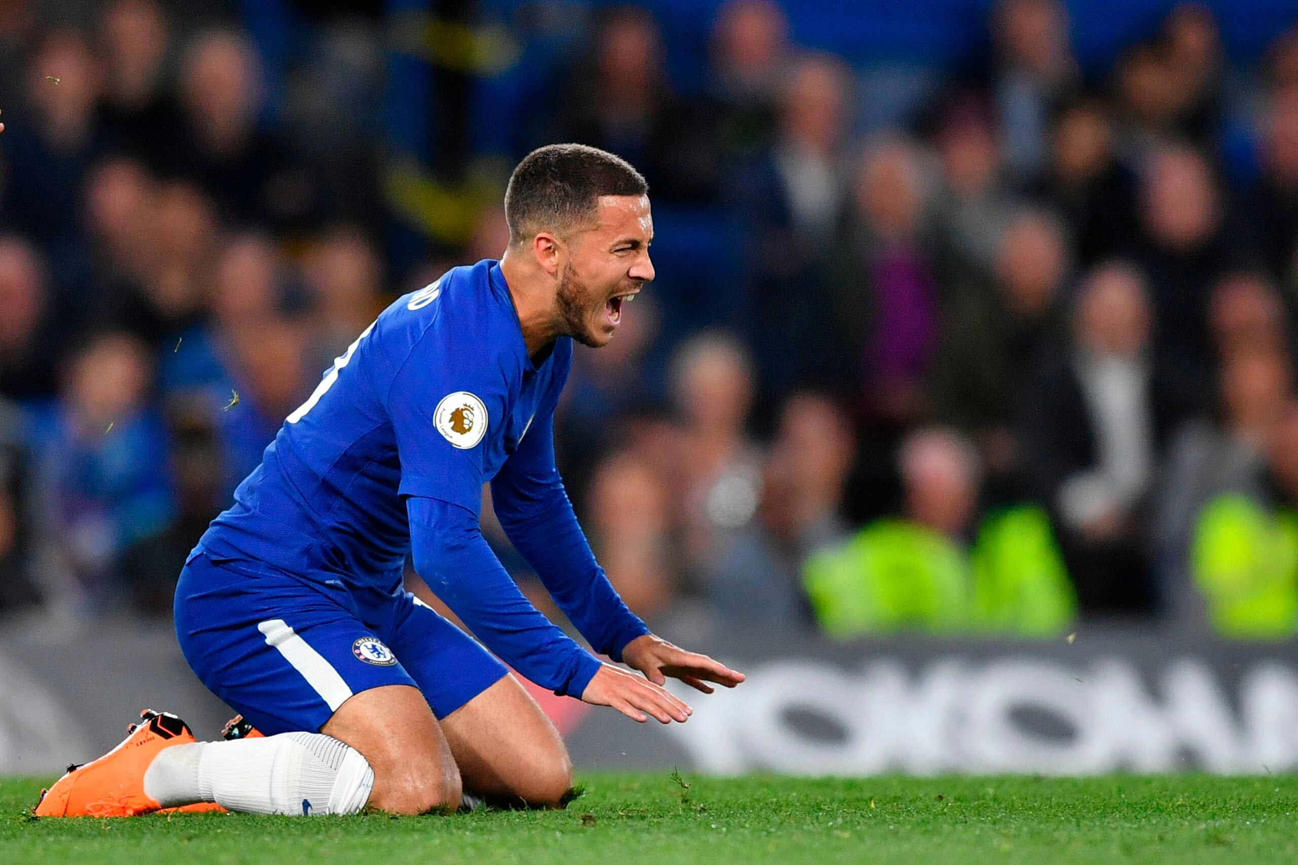 Chelsea's Belgian midfielder Eden Hazard reacts after a challenge during the English Premier League football match between Chelsea and Huddersfield Town at Stamford Bridge in London on May 9, 2018. (Photo by Ben STANSALL / AFP) / RESTRICTED TO EDITORIAL U