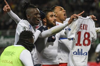 Lyon's French midfielder Nabil Fekir (C) shows his shirt as is congratulated by teammates after scoring during the French L1 football match between AS Saint-Etienne and Olympique Lyonnais, on November 5, 2017, at the Geoffroy Guichard stadium in Saint-Eti