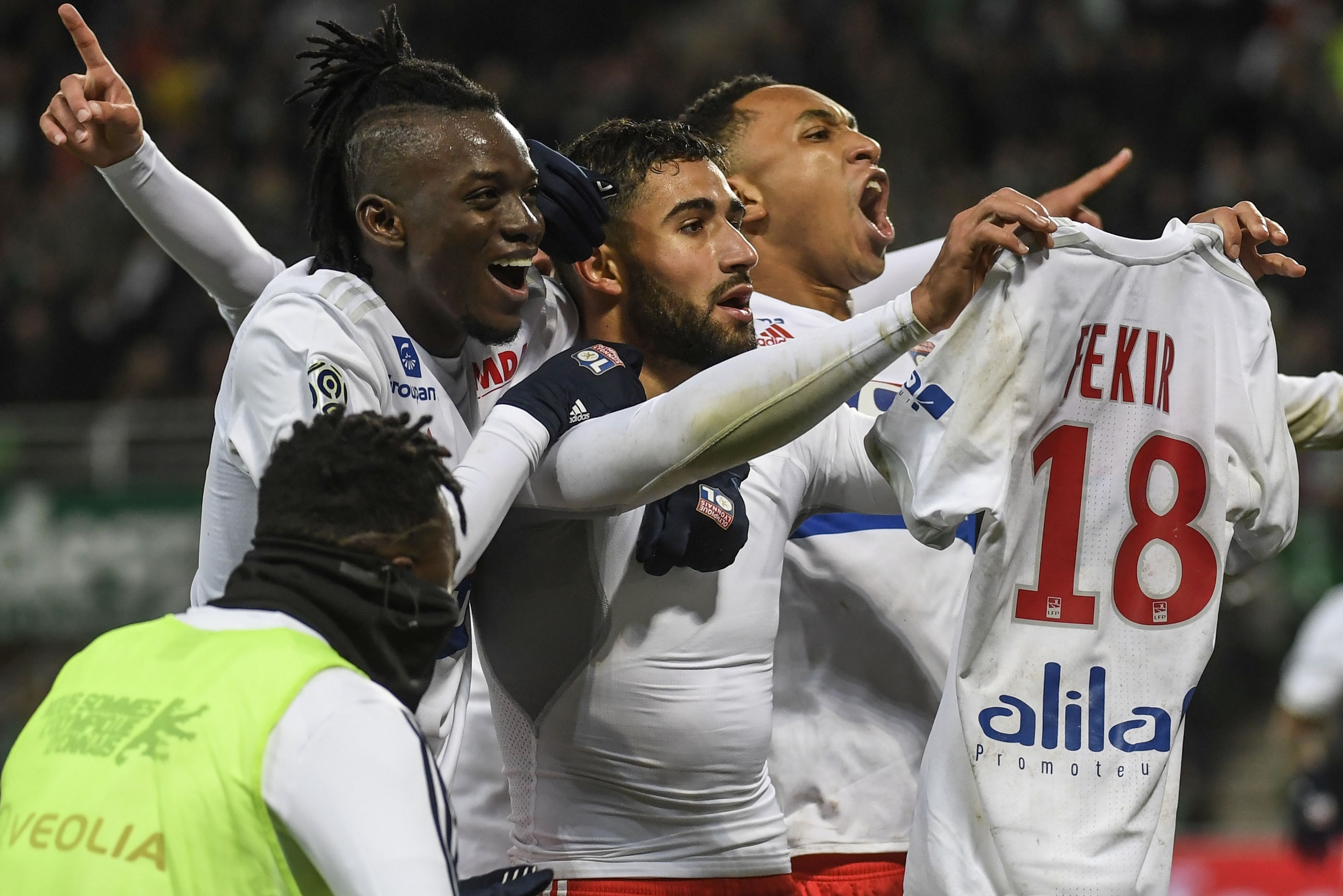 Lyon's French midfielder Nabil Fekir (C) shows his shirt as is congratulated by teammates after scoring during the French L1 football match between AS Saint-Etienne and Olympique Lyonnais, on November 5, 2017, at the Geoffroy Guichard stadium in Saint-Eti