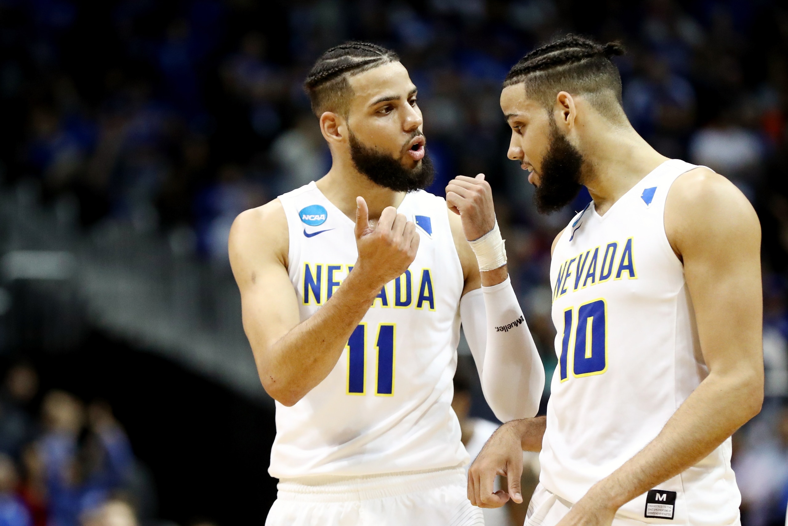 ATLANTA, GA - MARCH 22: Cody Martin #11 and Caleb Martin #10 of the Nevada Wolf Pack discuss the play against the Loyola Ramblers in the second half during the 2018 NCAA Men's Basketball Tournament South Regional at Philips Arena on March 22, 2018 in Atla
