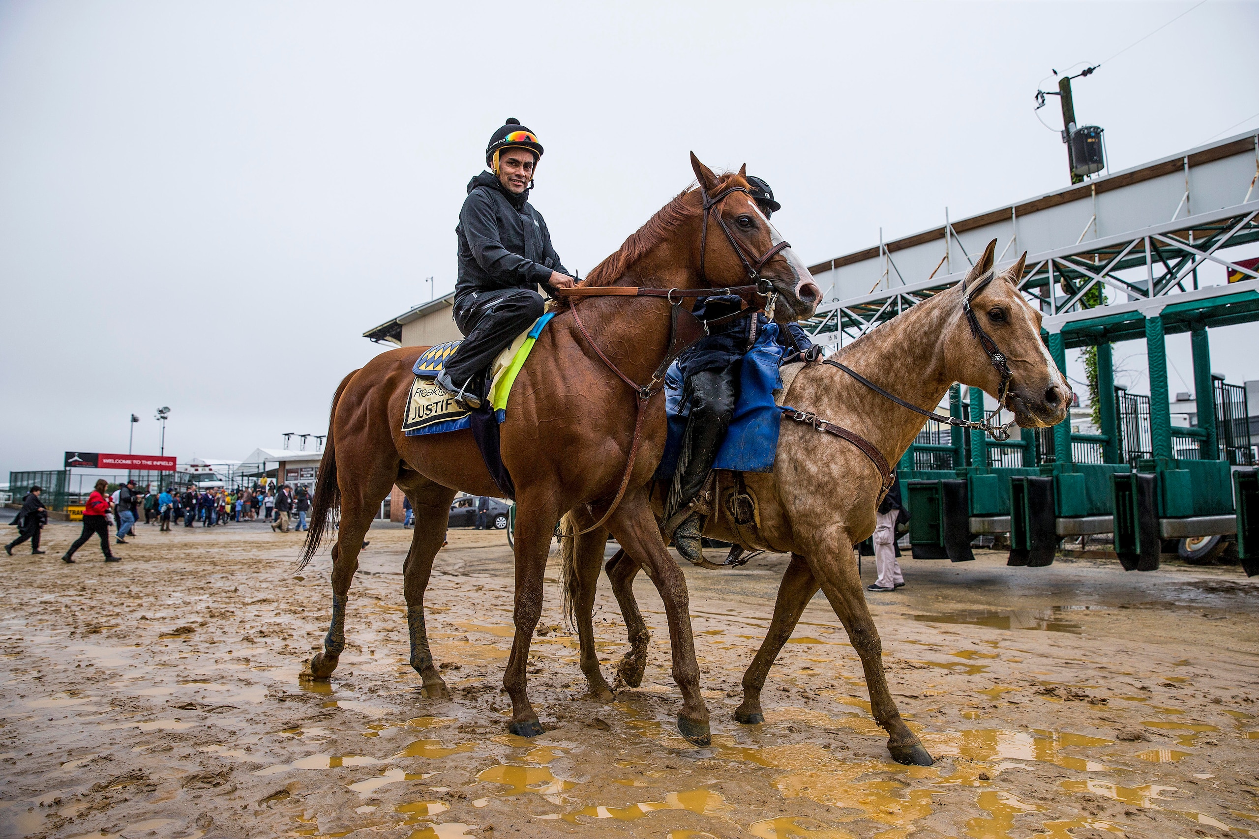 BALTIMORE, MD - MAY 17:  Justify with Humberto Gomez up if accompanied off the track by assistant trainer Jimmy Barnes at Pimlico Racecourse on May 17, 2018 in Baltimore, Maryland. (Photo by Alex Evers/Eclipse Sportswire/Getty Images)