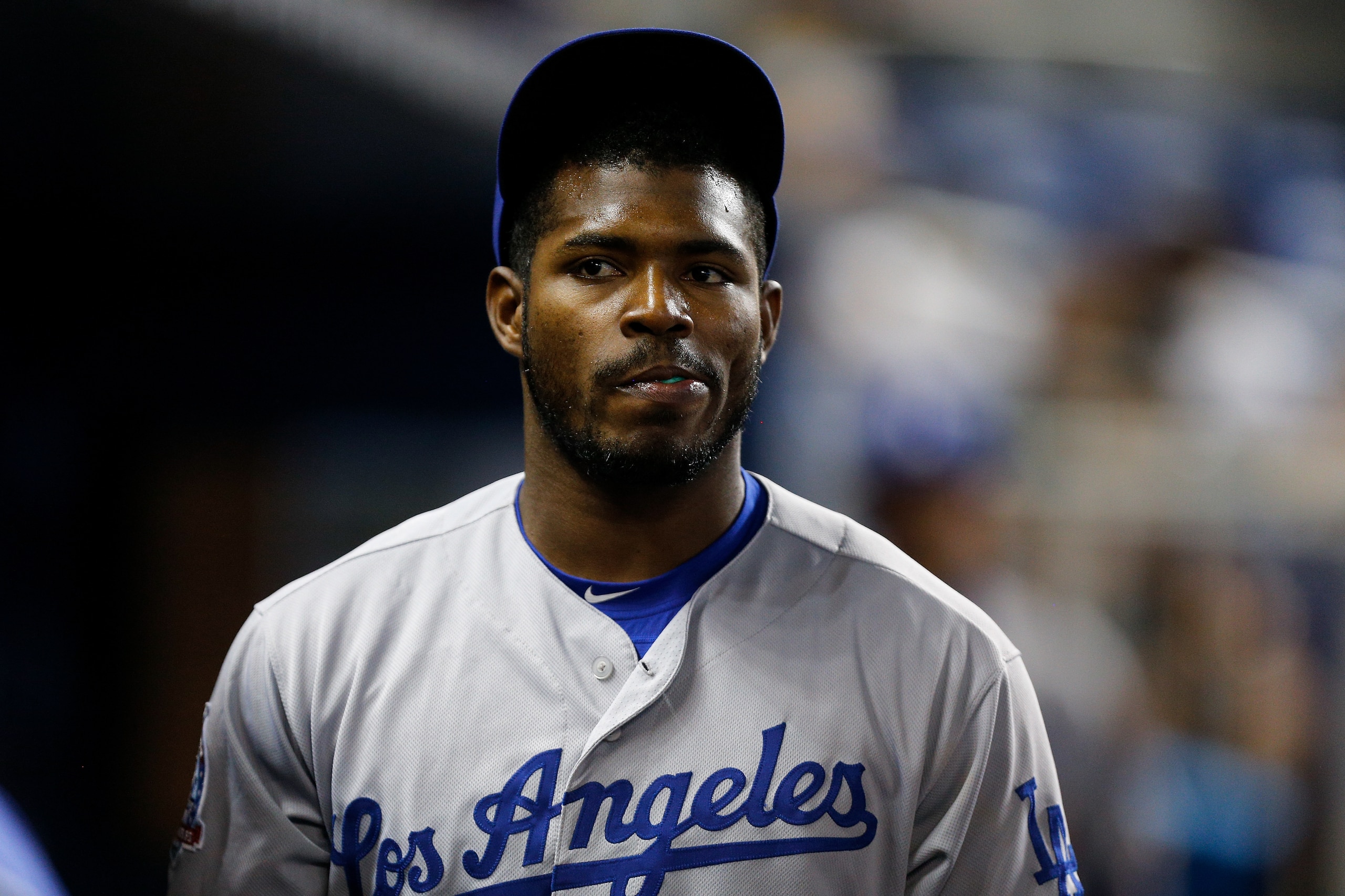 MIAMI, FL - MAY 17:  Yasiel Puig #66 of the Los Angeles Dodgers looks on in the dugout against the Miami Marlins at Marlins Park on May 17, 2018 in Miami, Florida.  (Photo by Michael Reaves/Getty Images)