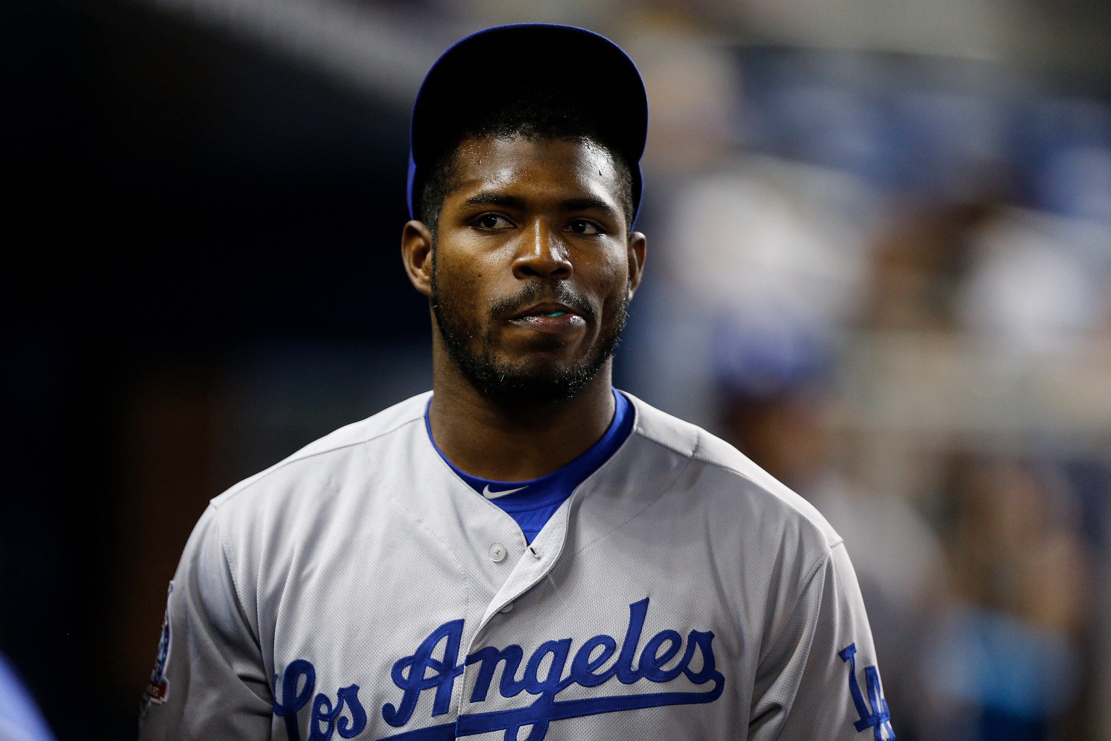 MIAMI, FL - MAY 17:  Yasiel Puig #66 of the Los Angeles Dodgers looks on in the dugout against the Miami Marlins at Marlins Park on May 17, 2018 in Miami, Florida.  (Photo by Michael Reaves/Getty Images)