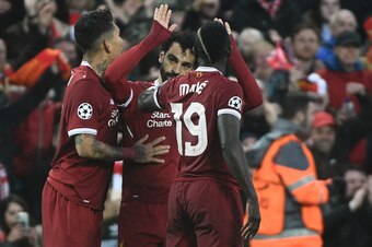 Liverpool's Egyptian midfielder Mohamed Salah (C) celebrates after scoring with Liverpool's Brazilian midfielder Roberto Firmino (L) and Liverpool's Senegalese midfielder Sadio Mane during the UEFA Champions League first leg semi-final football match betw