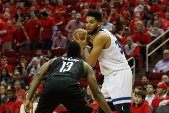 HOUSTON, TX - APRIL 25:  Karl-Anthony Towns #32 of the Minnesota Timberwolves controls the ball defended by James Harden #13 of the Houston Rockets in the second half during Game Five of the first round of the 2018 NBA Playoffs at Toyota Center on April 2