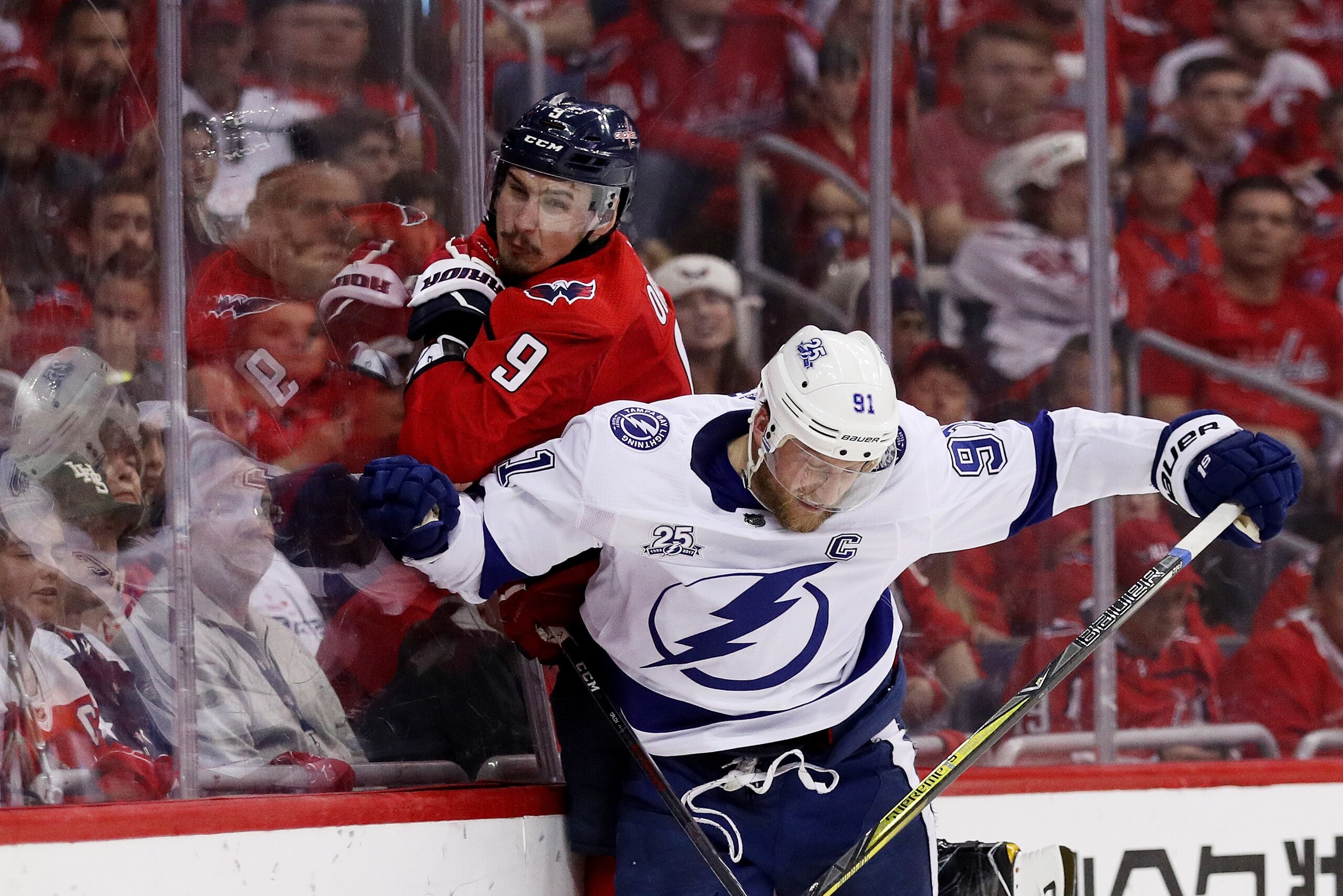 WASHINGTON, DC - MAY 21:  Steven Stamkos #91 of the Tampa Bay Lightning checks Dmitry Orlov #9 of the Washington Capitals in the third period in Game Six of the Eastern Conference Finals during the 2018 NHL Stanley Cup Playoffs at Capital One Arena on May