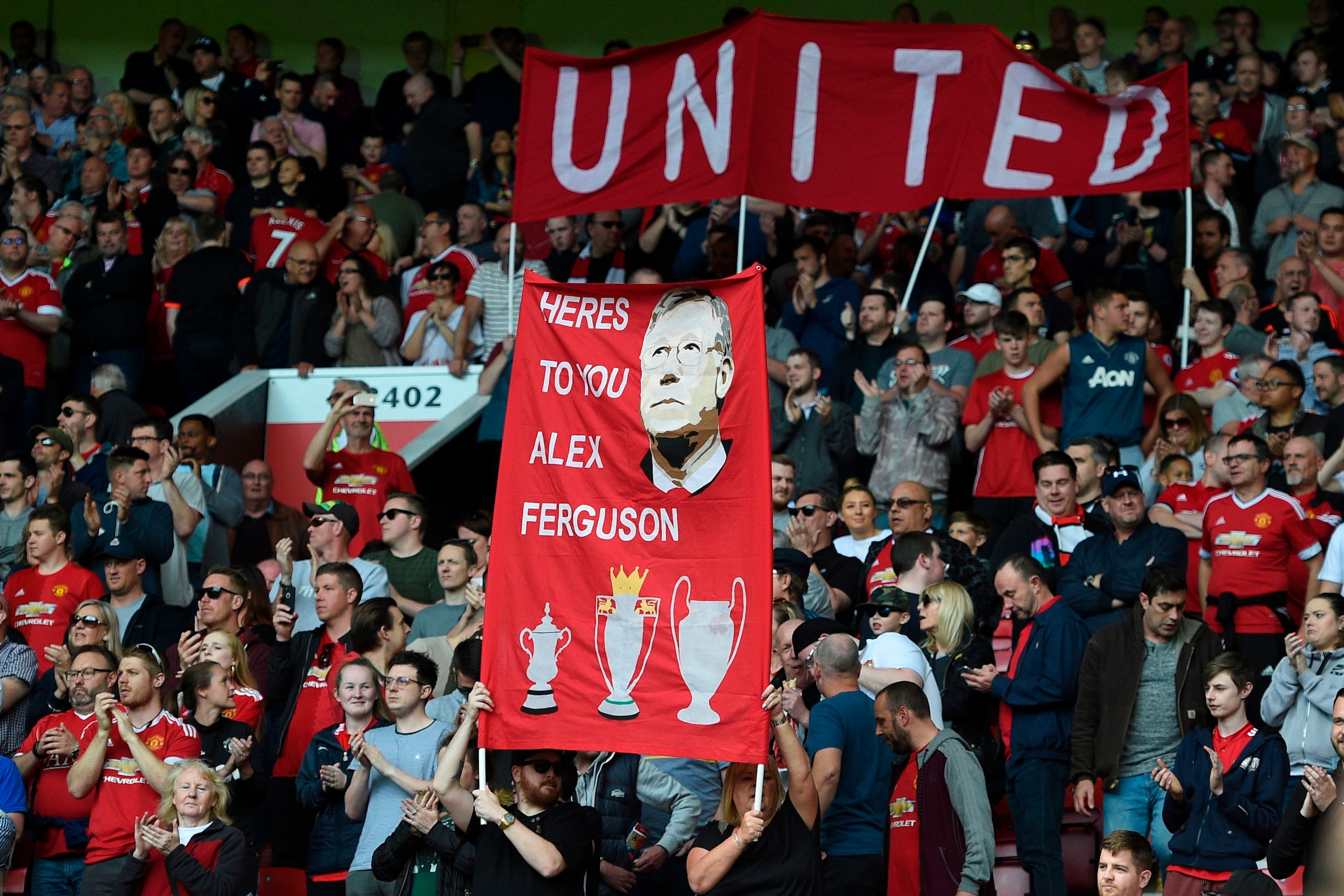 TOPSHOT - A banner wishing former manager Alex Ferguson, who is convalescing after having emergency surgery on a brain haemorrhage, is seen during the English Premier League football match between Manchester United and Watford at Old Trafford in Mancheste