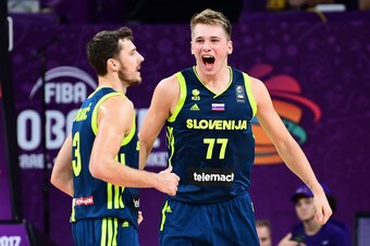 Slovenia's guard Luka Doncic (R) and Goran Dragic (L) celebrate after scoring during the FIBA Eurobasket 2017 men's semi-final basketball match between Spain and Slovenia at the Fenerbahce Ulker Sport Arena in Istanbul on September 14, 2017. / AFP PHOTO /