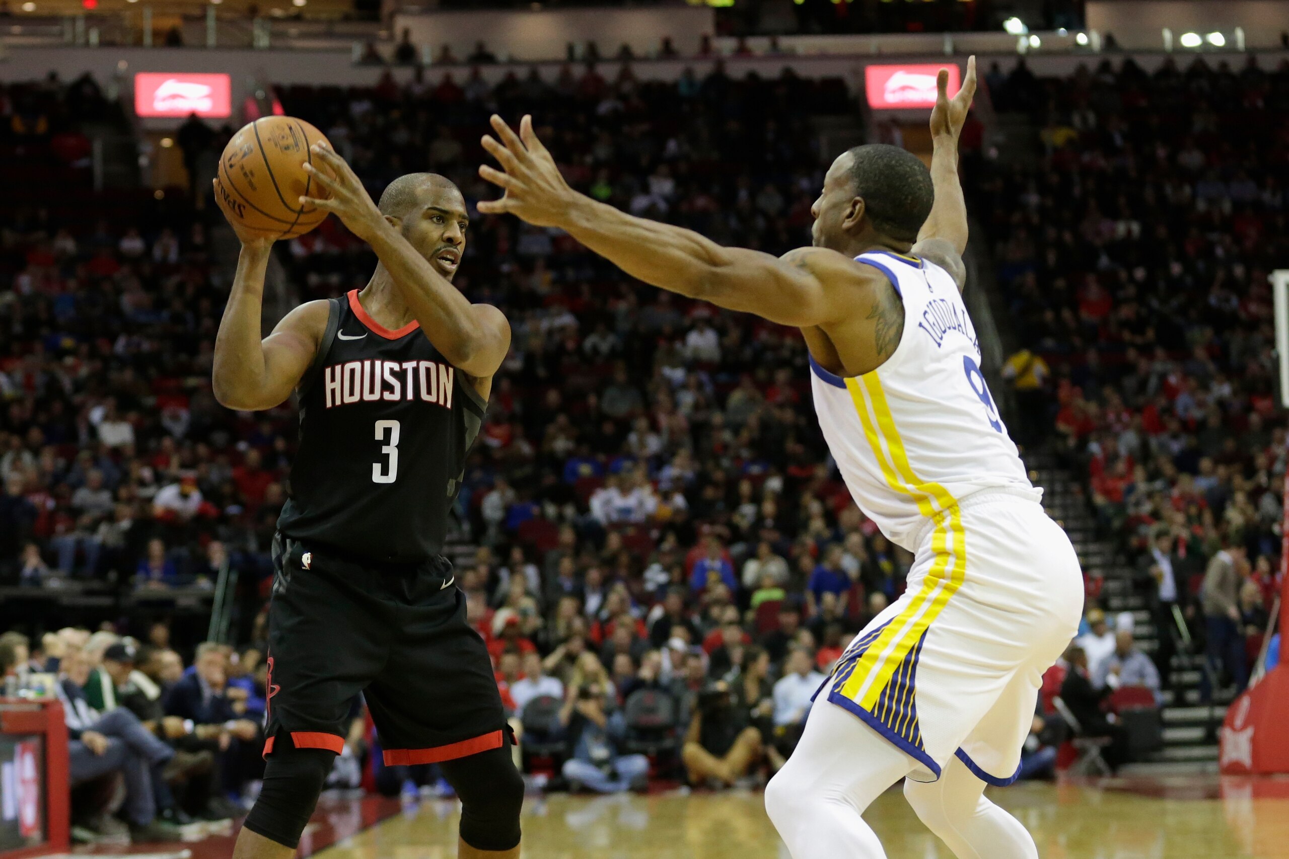 HOUSTON, TX - JANUARY 04:  Chris Paul #3 of the Houston Rockets controls the ball defended by Andre Iguodala #9 of the Golden State Warriors in the first half at Toyota Center on January 4, 2018 in Houston, Texas.  NOTE TO USER: User expressly acknowledge