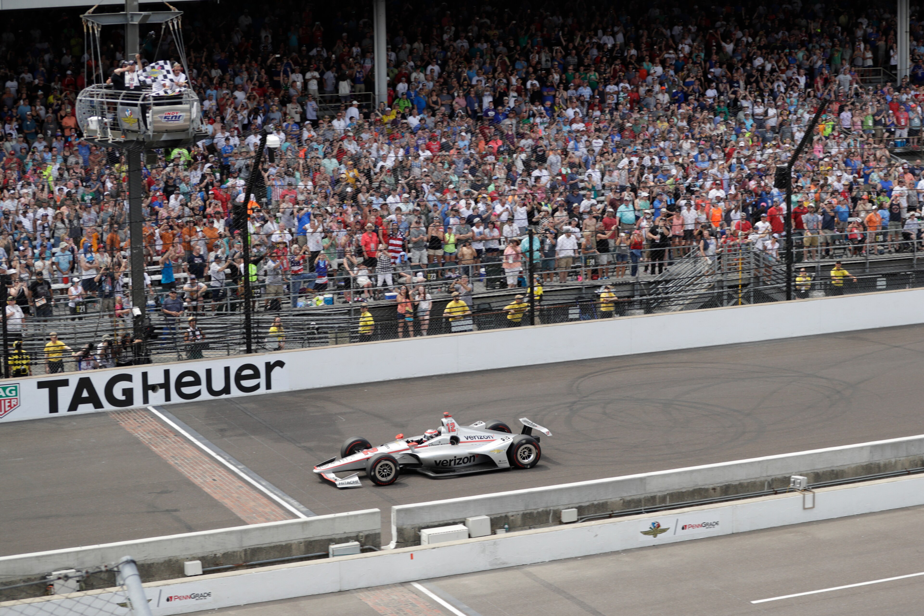 Power gets the checkered flag as he approaches the finish line.