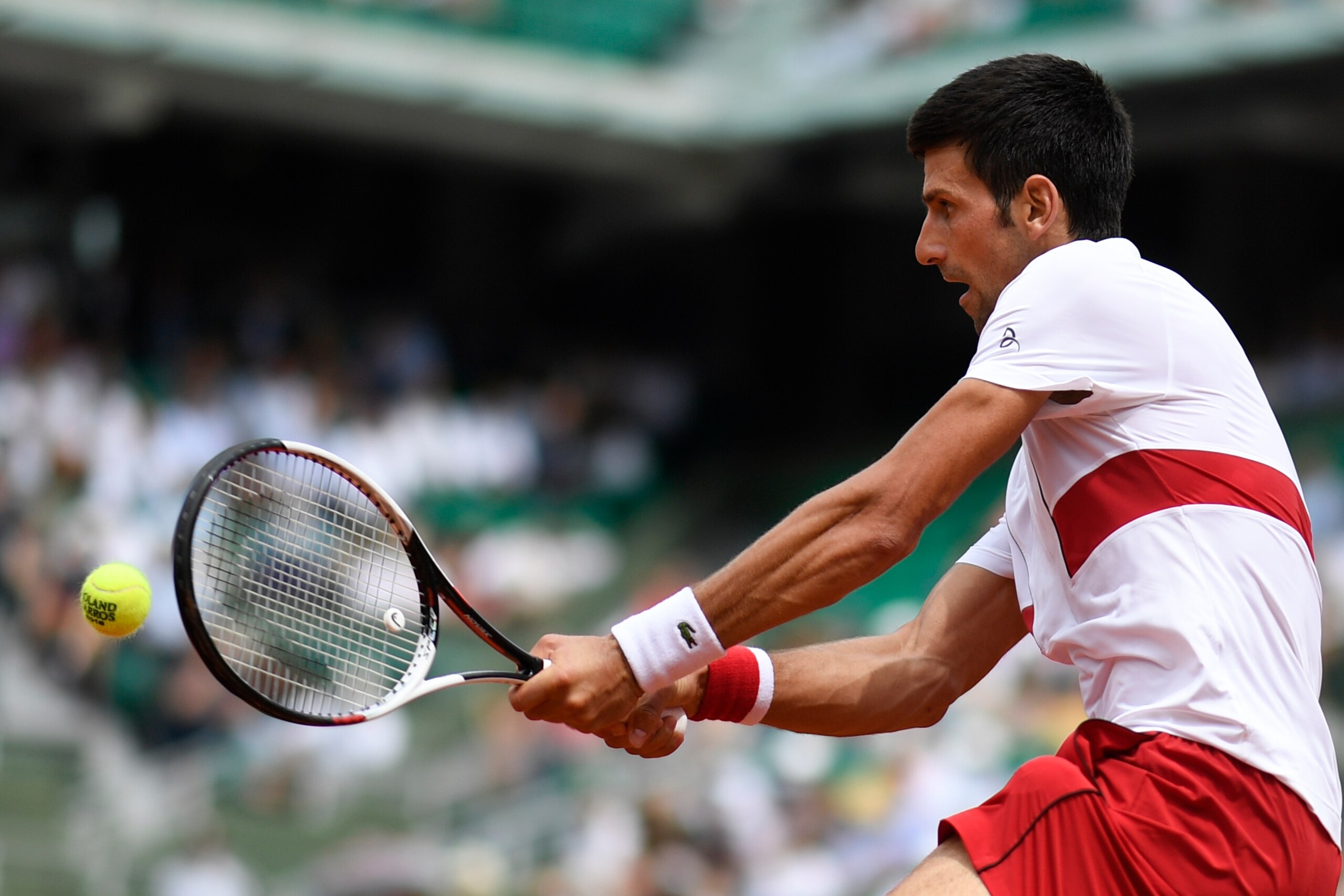 Serbia's Novak Djokovic plays a return to Brazil's Rogerio Dutra Silva during their men's singles first round match on day two of The Roland Garros 2018 French Open tennis tournament in Paris on May 28, 2018. (Photo by CHRISTOPHE SIMON / AFP)        (Phot
